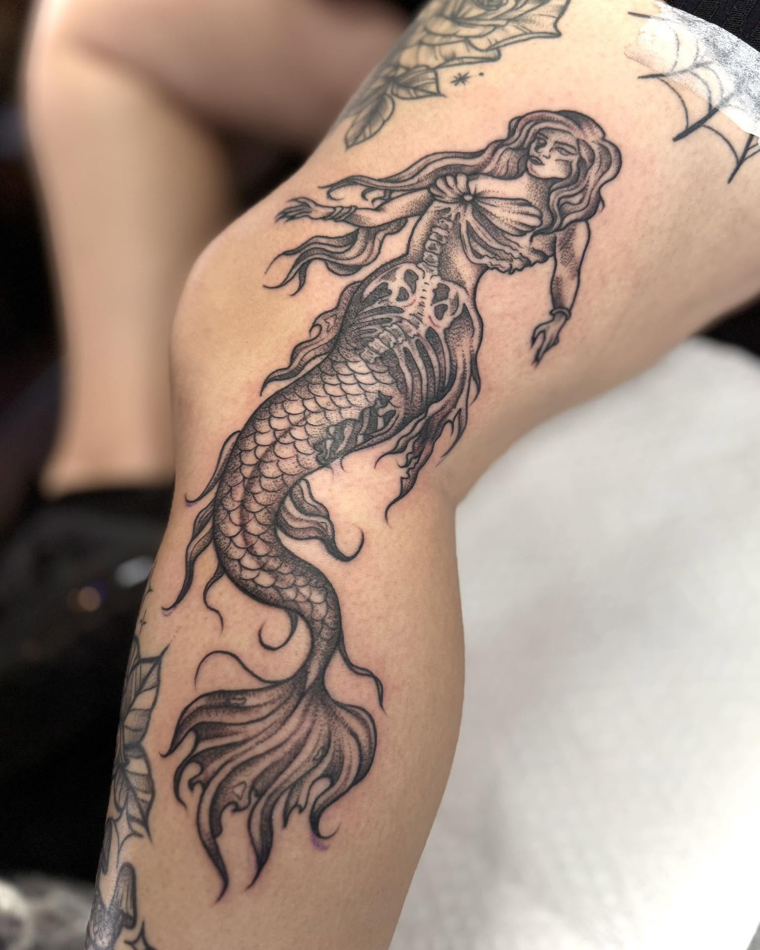 Mermaid black and grey tattoo on the thigh by Eden Rose, Kalama, Washington