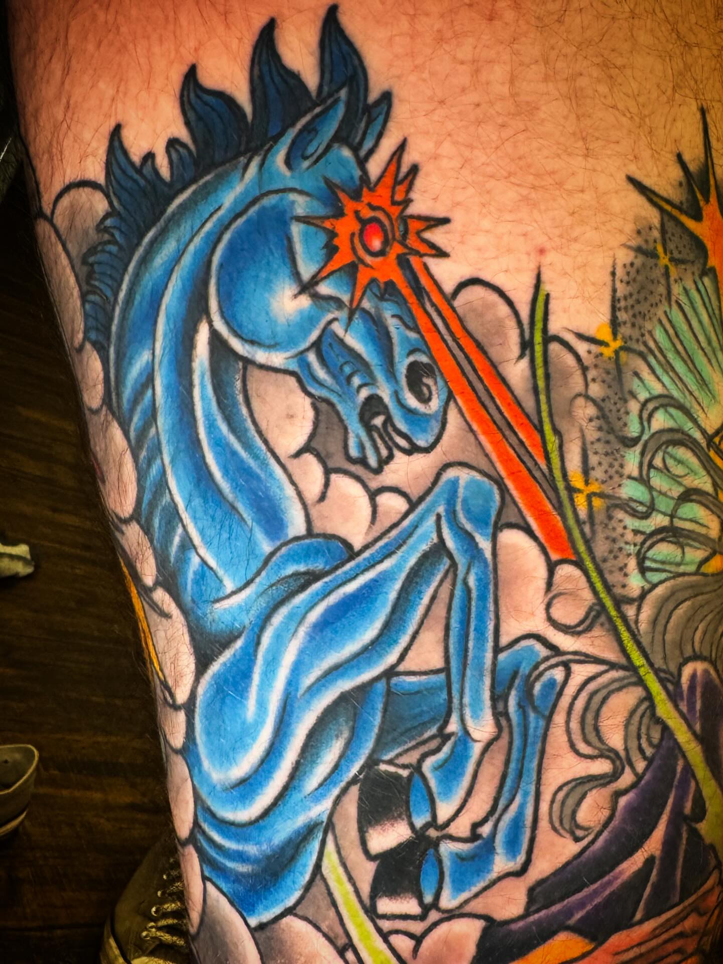 Blue dragon anime tattoo on the thigh by Bob Lackner