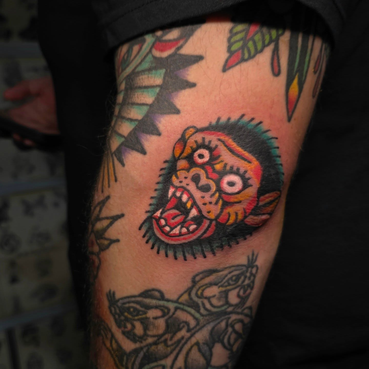 Joker head American traditional tattoo on the forearm by Mitch Braver