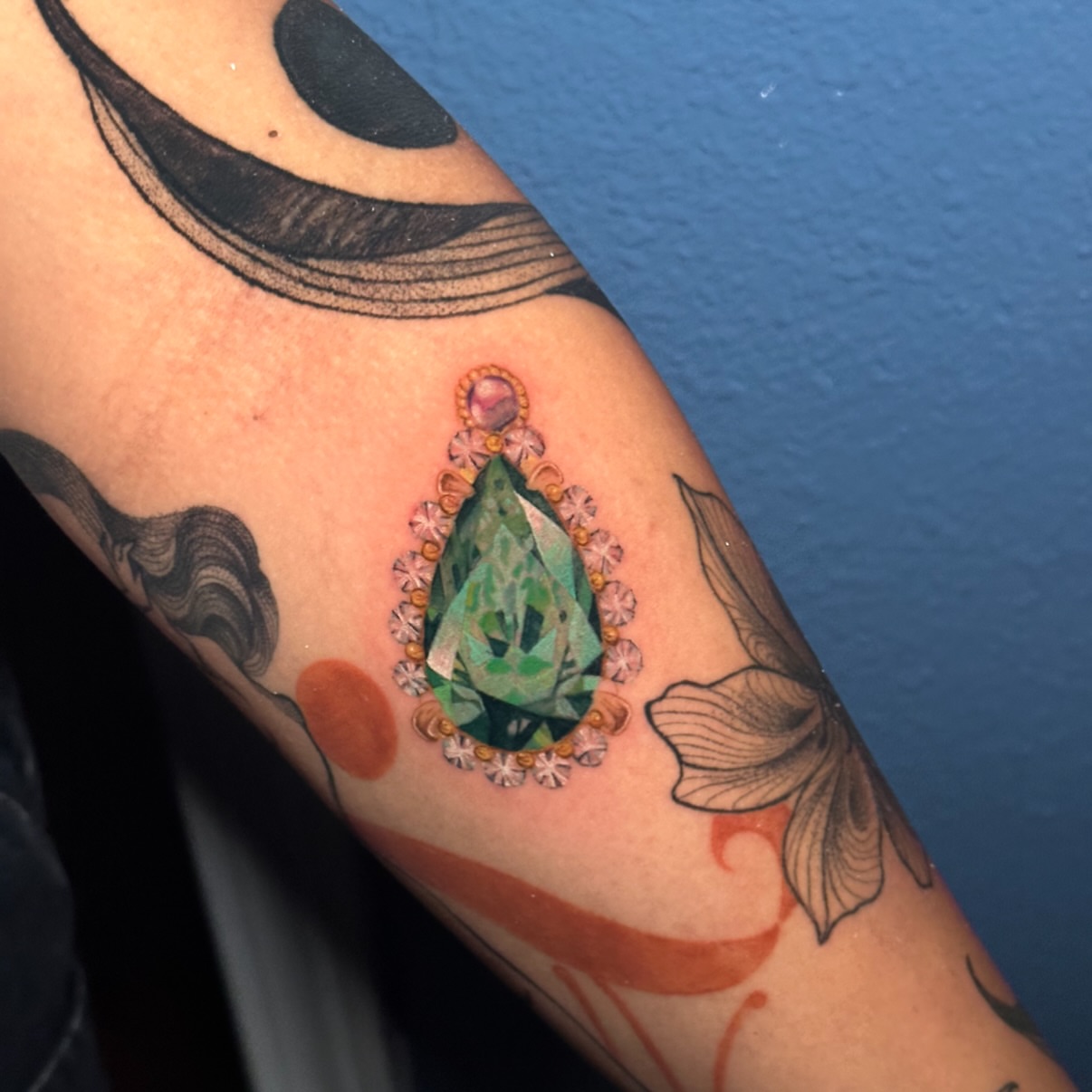 Gemstone realism tattoo on the forearm by Summers