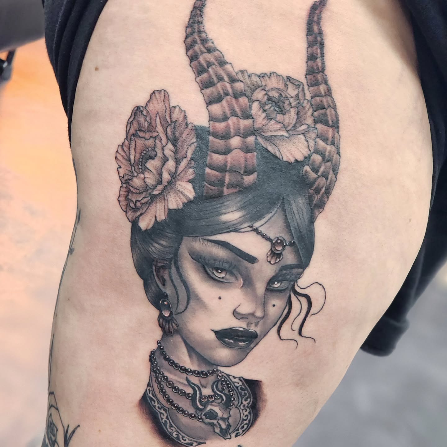 Woman with horns realism tattoo on the thigh by Robert Glover