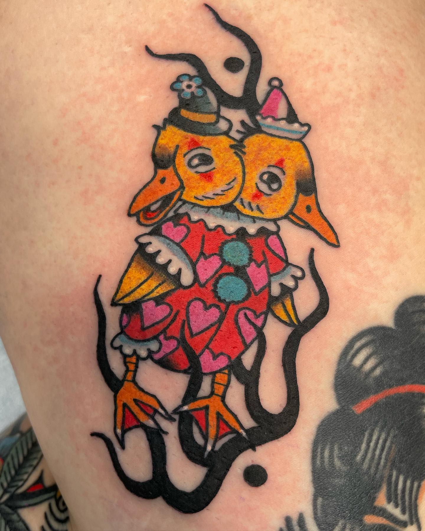 Dueling birds American traditional tattoo on the thigh by Gerald Bellmore