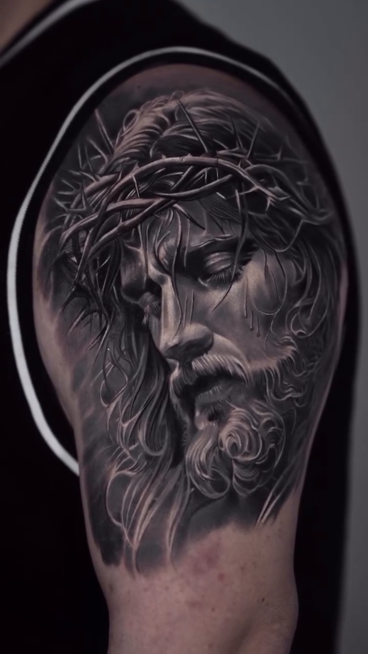 Jesus Christ portrait Chicano tattoo on the upper arm by Luis Manuel Olivera, North Miami, Florida