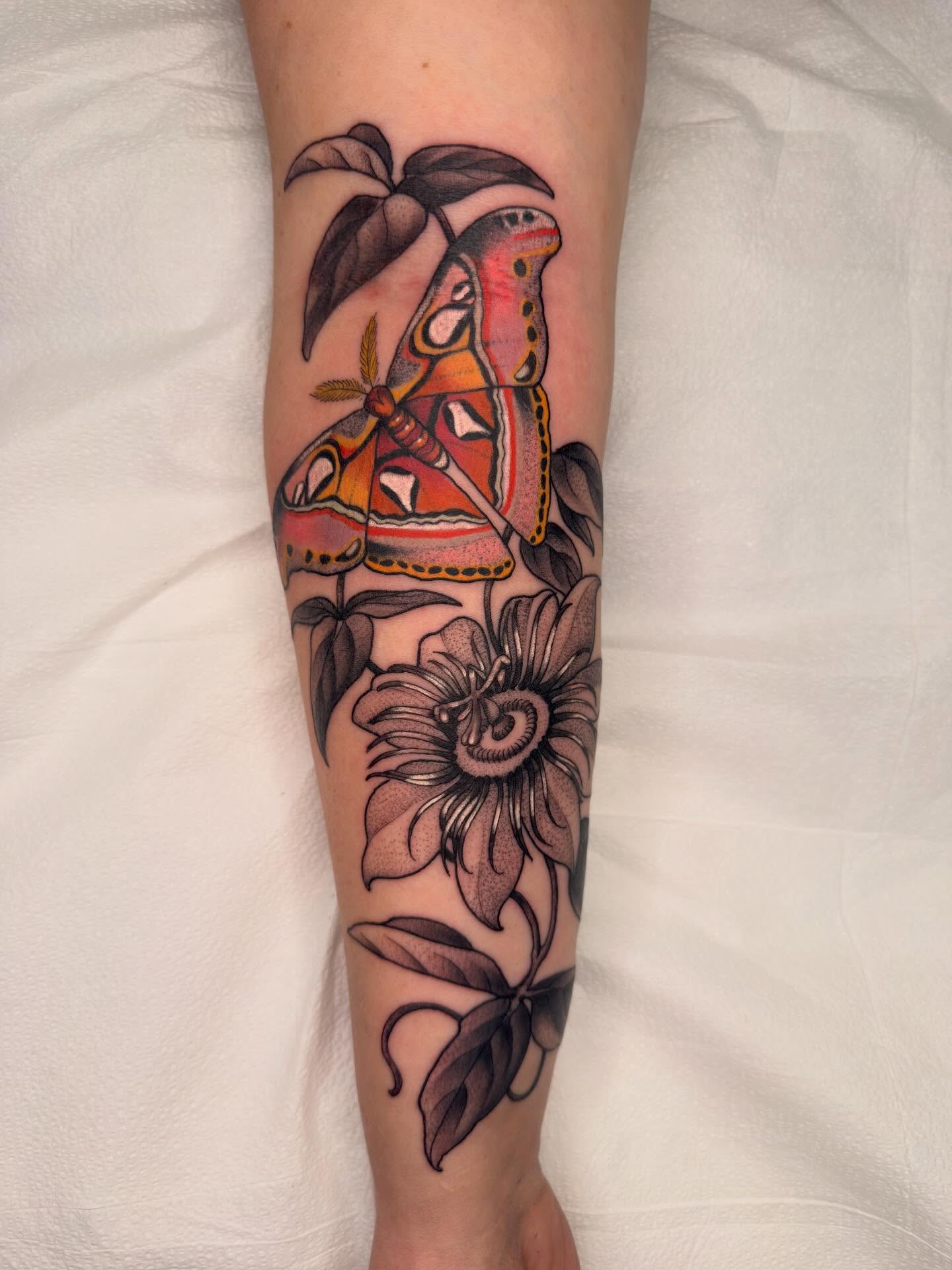 Butterfly and flower American traditional tattoo on the forearm by Samantha Compasso Ford