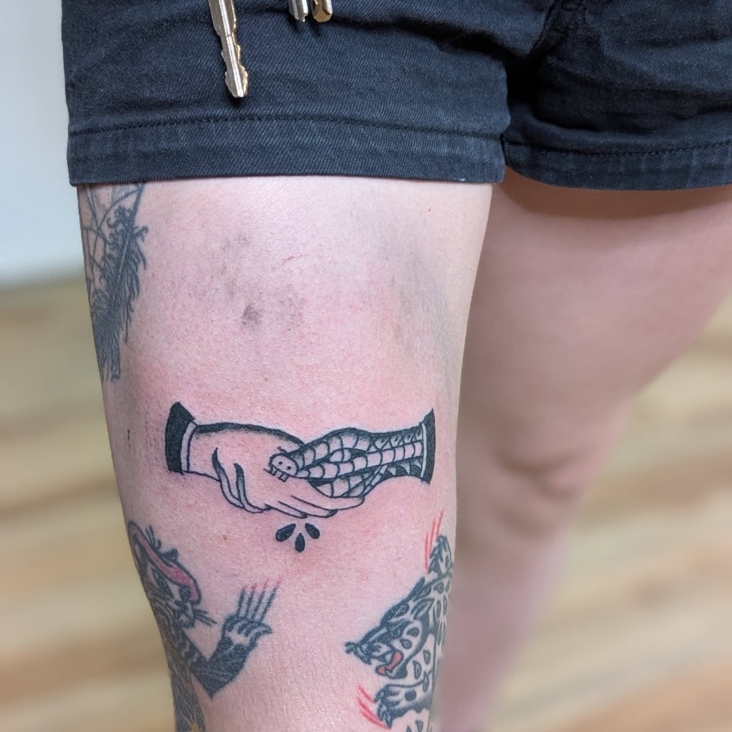 Handshake American traditional tattoo on the forearm by Jon Sedor