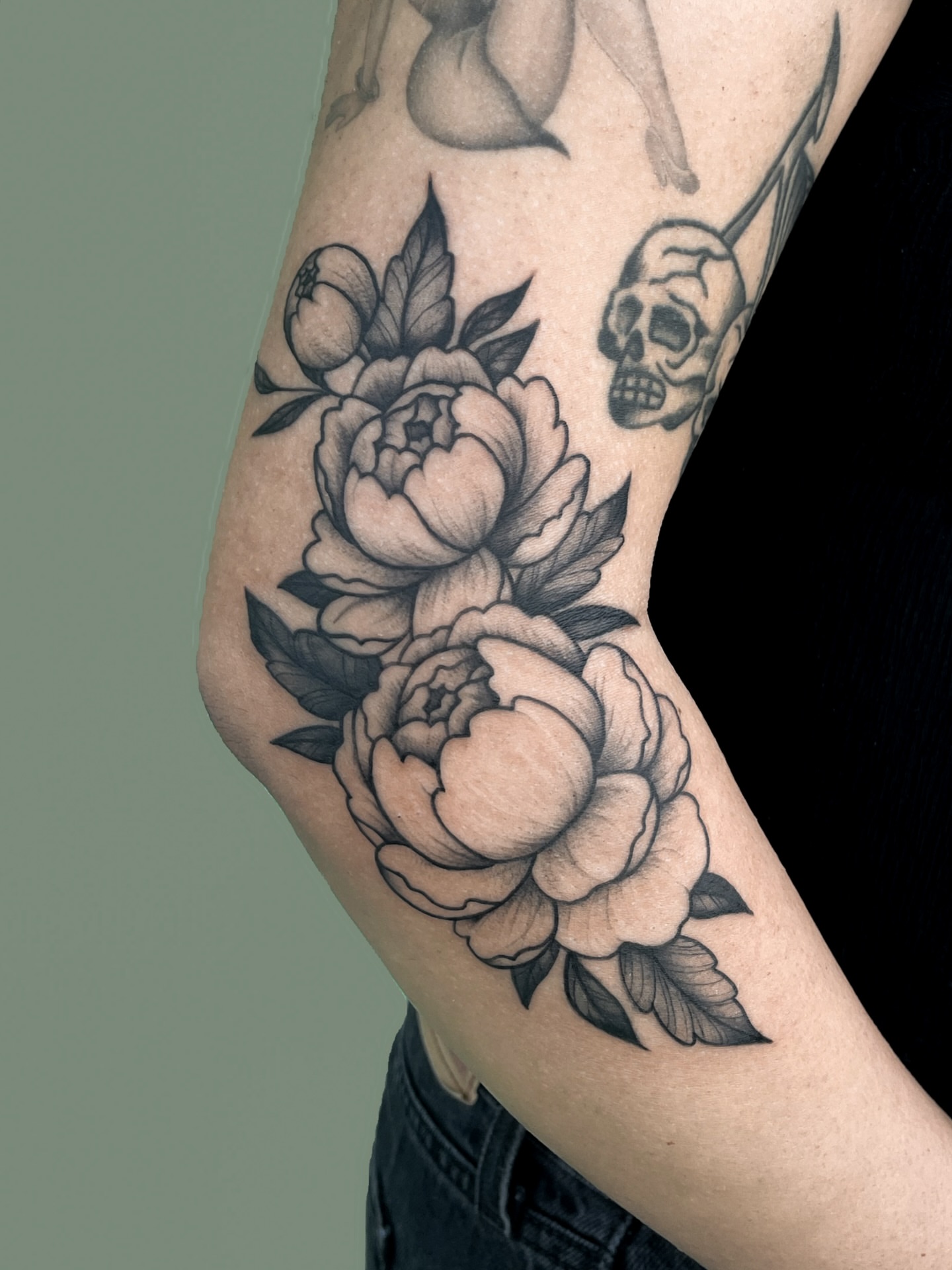 Peony flowers black and grey tattoo on the forearm by nina