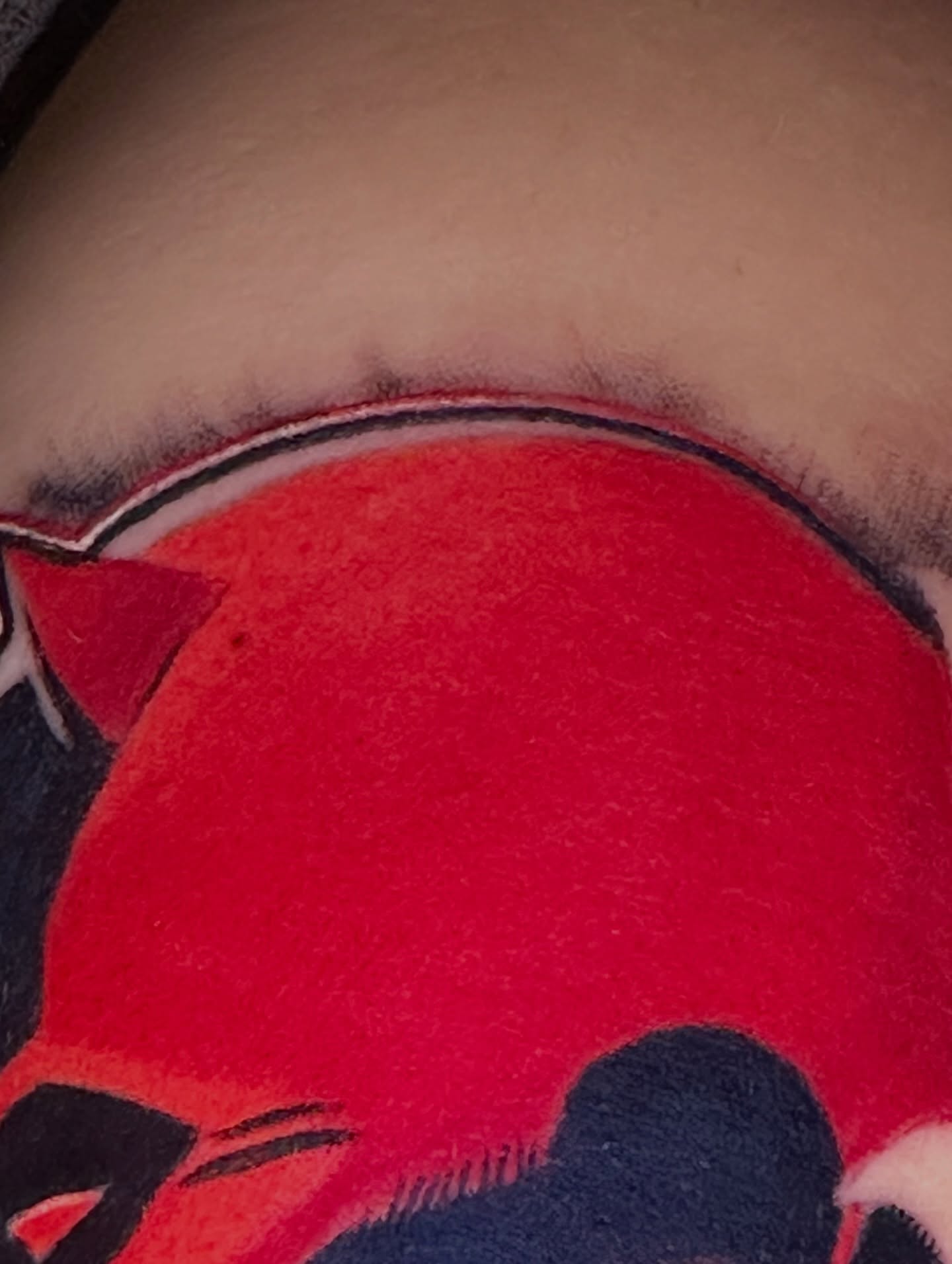 Red circle dotwork tattoo on the chest by Robert Douglas