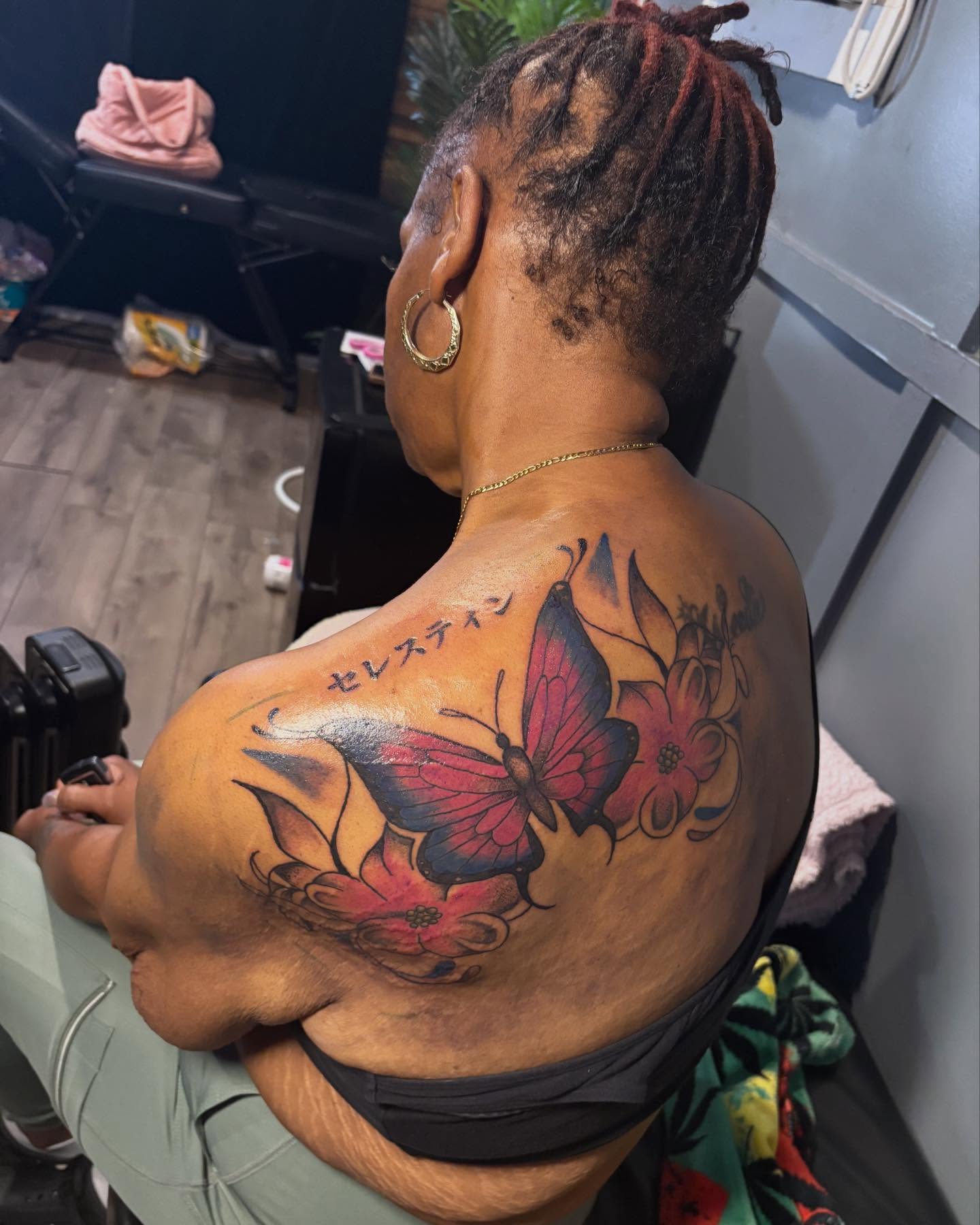Butterfly and flowers new school tattoo on the shoulder by SpicyMvstardInkk
