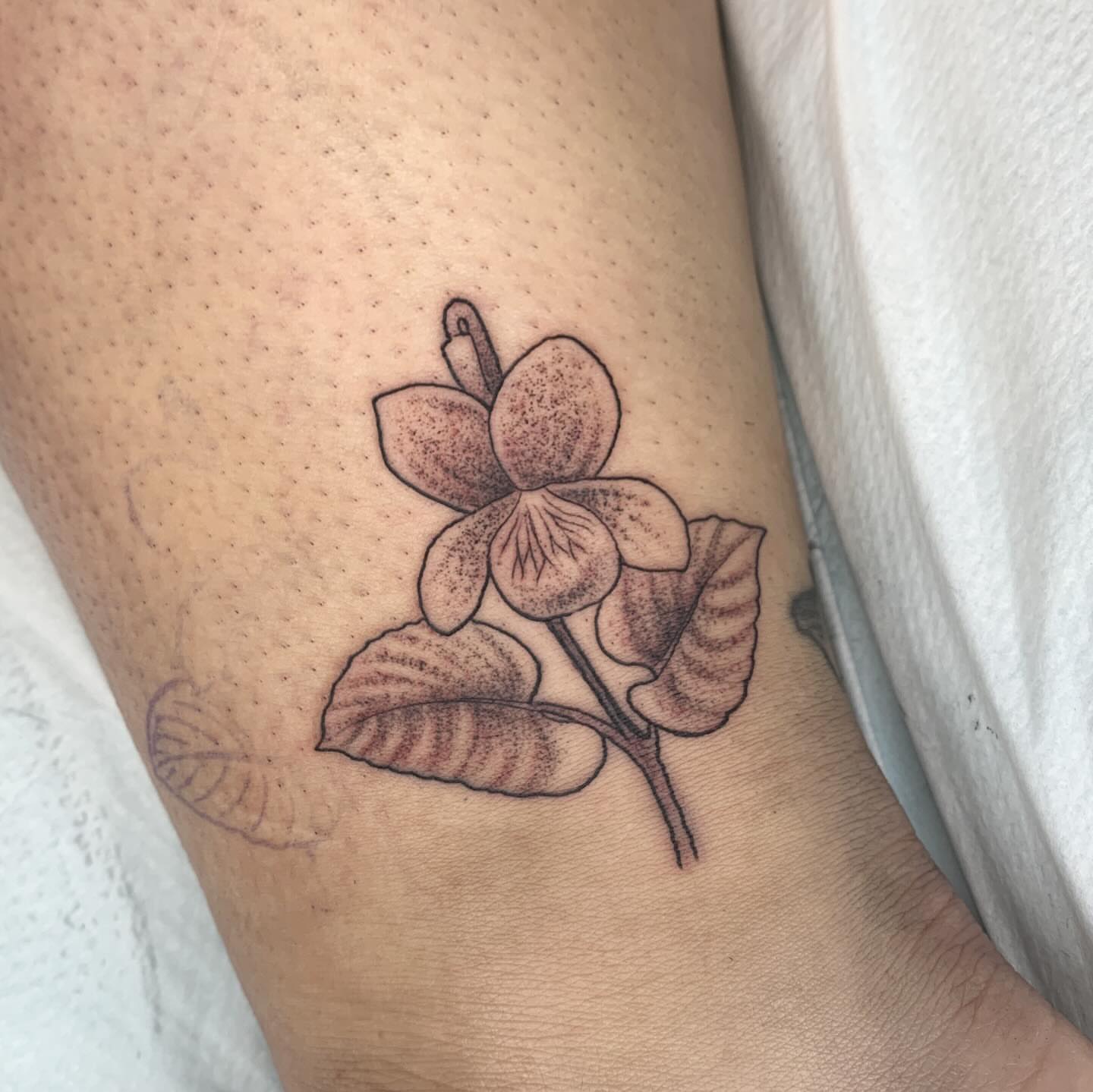 Orchid dotwork tattoo on the thigh by Kitty Jones, Berkeley, California