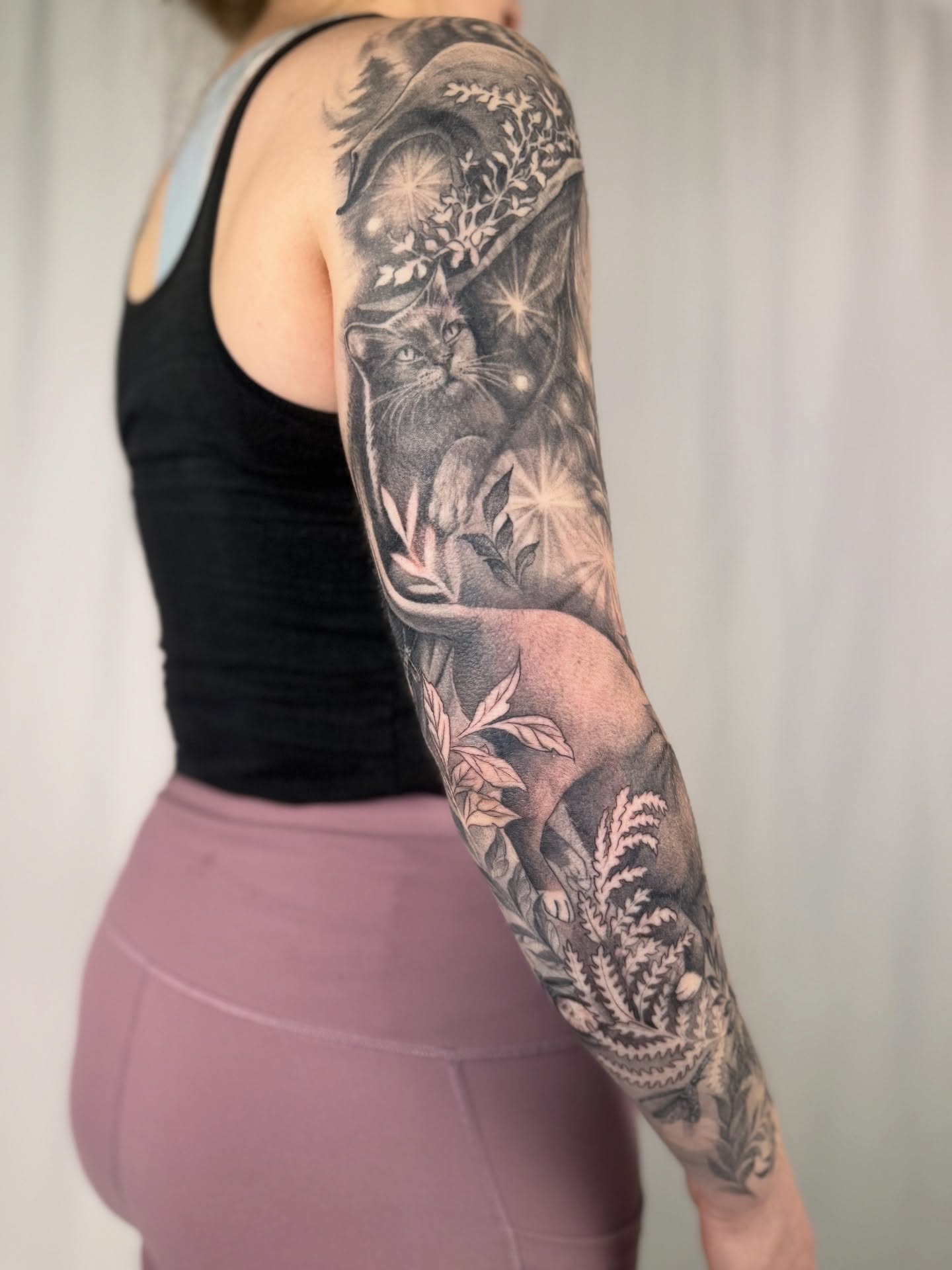 Cat and foliage realism tattoo on the forearm by Sam Minter, Grafton, Massachusetts