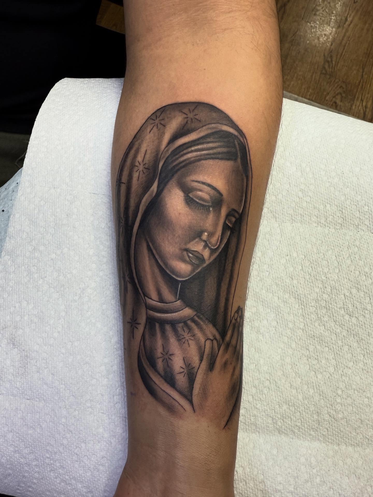 Religious figure realism tattoo on the forearm by Jameson William Cowan