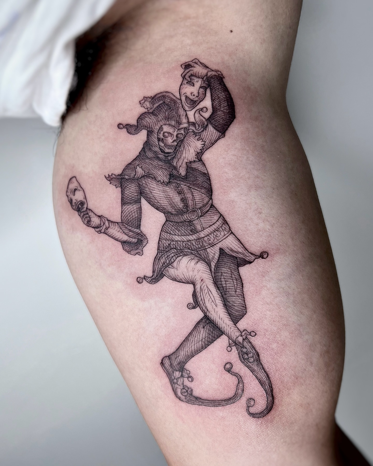 Jester and jester black and grey tattoo on the thigh by Jorge Nox