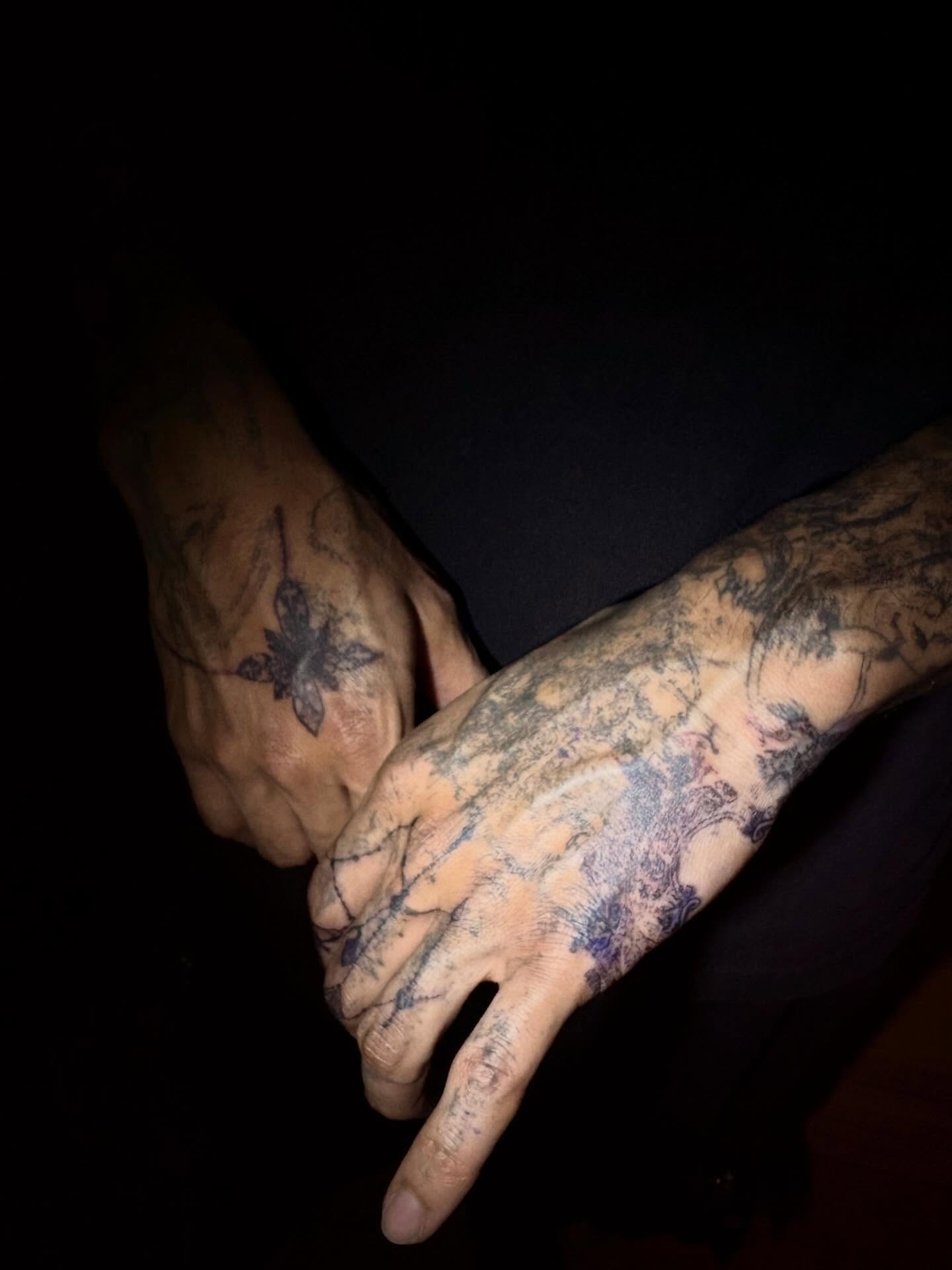 Floral design black and grey tattoo on the hand by madeline
