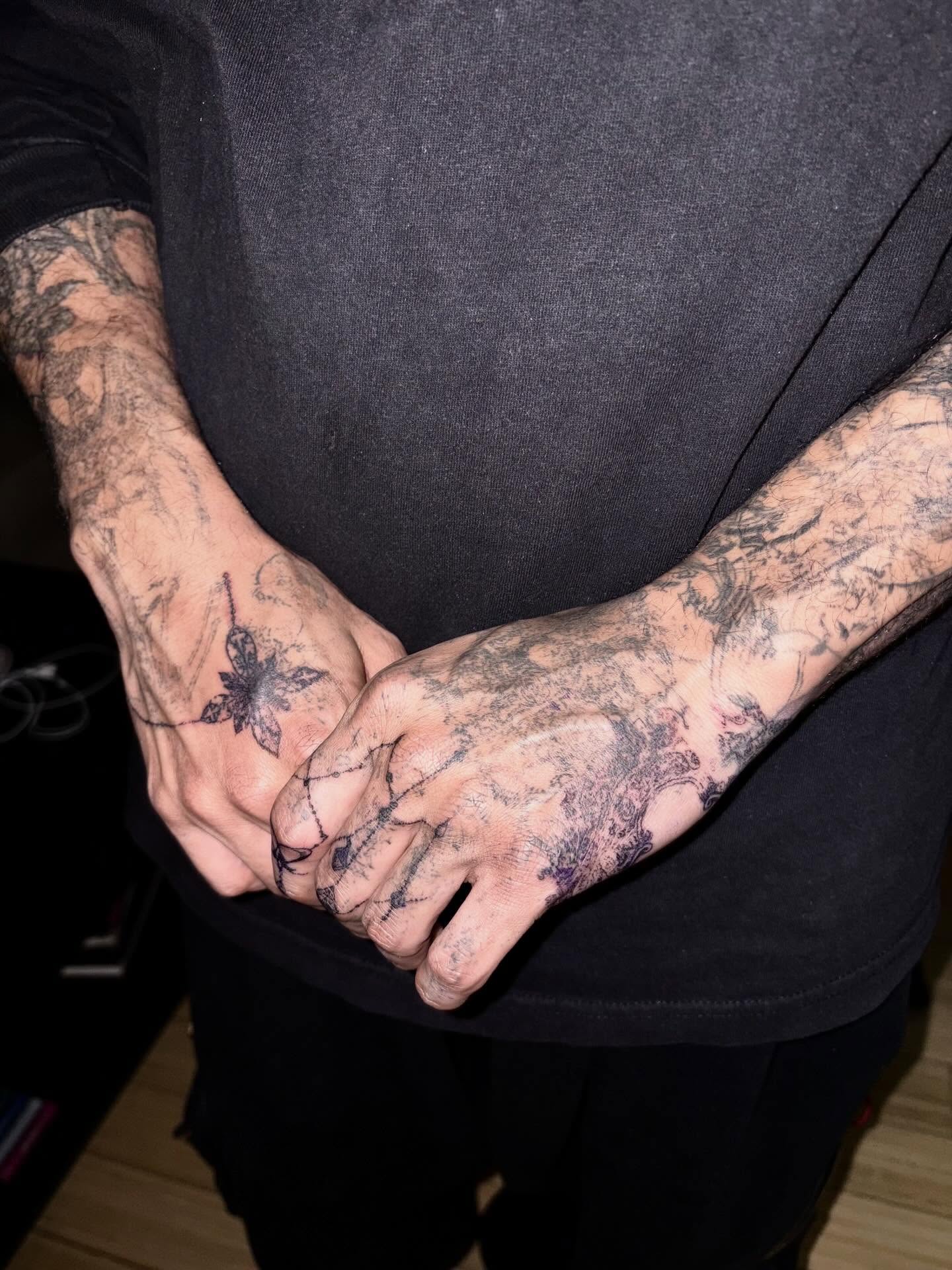 Floral design black and grey tattoo on the hand by madeline