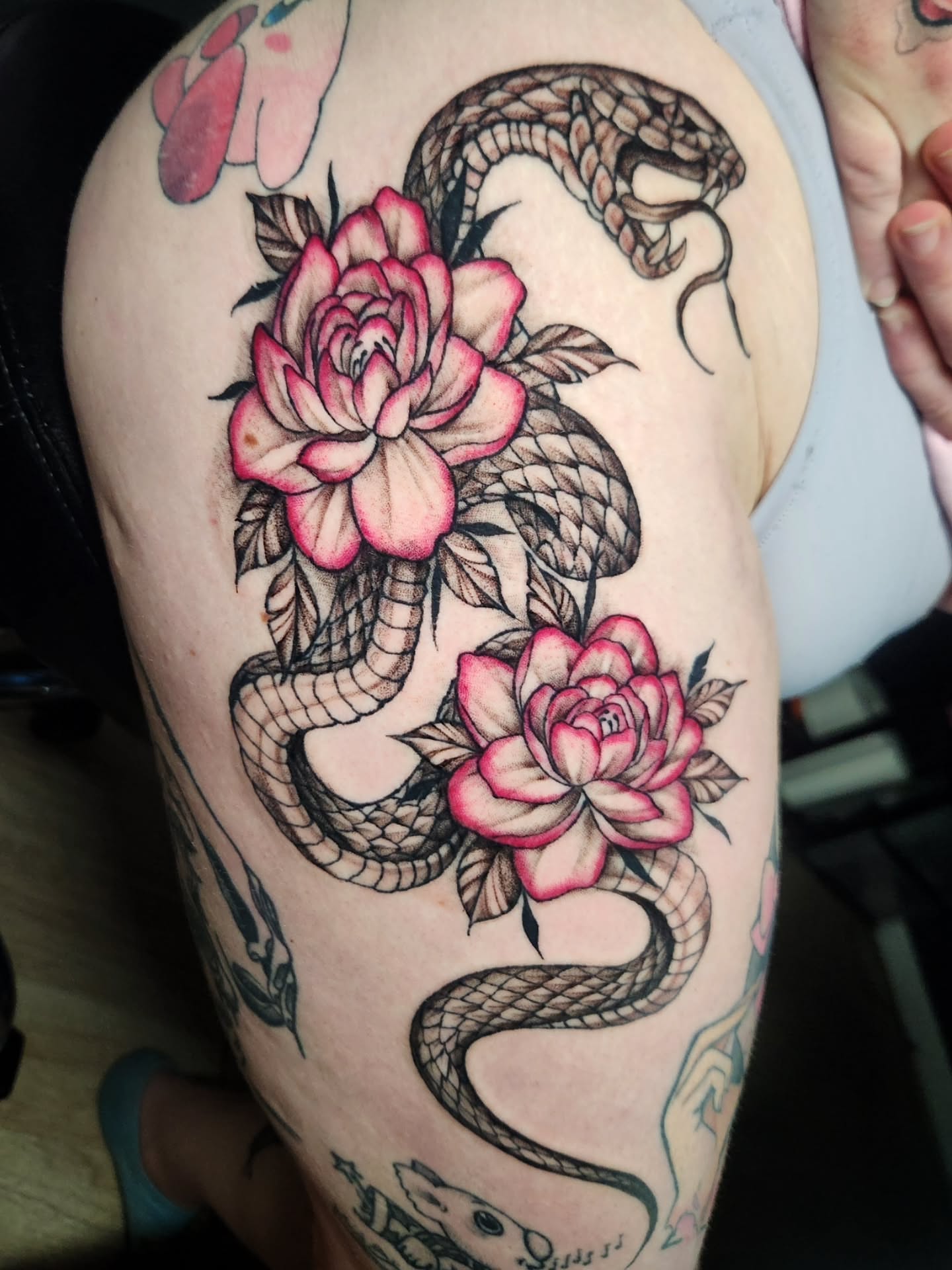 Snake and roses American traditional tattoo on the thigh by Abby Renteria
