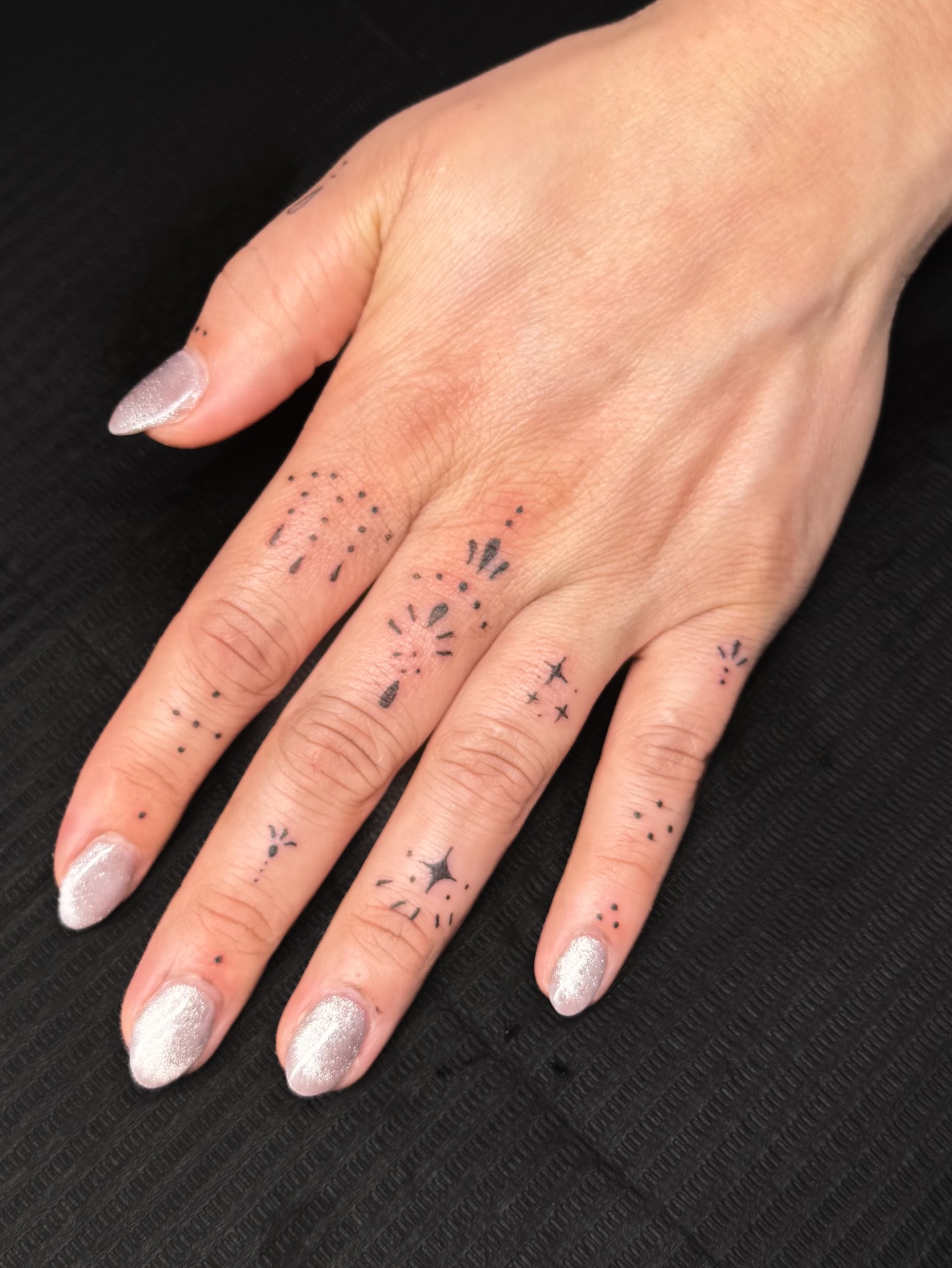 Stars and dots dotwork tattoo on the hand by Nicole