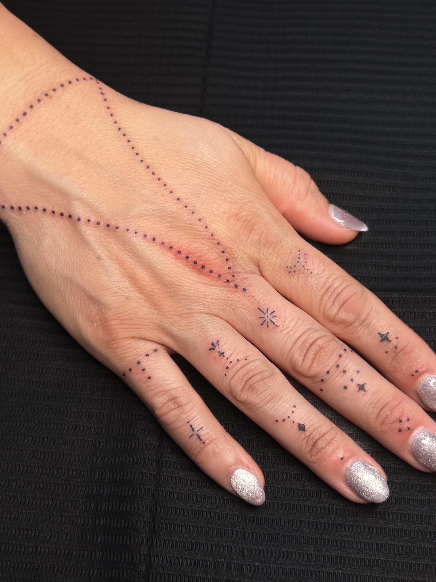 Constellation dotwork tattoo on the hand by Nicole