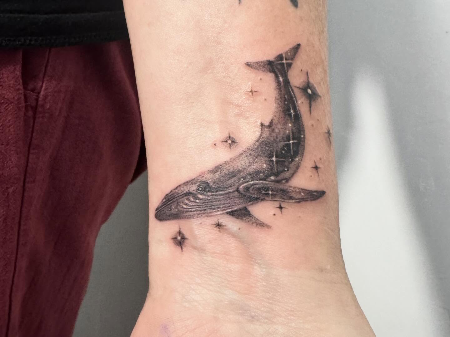 Whale black and grey tattoo on the forearm by Tianna Osborne