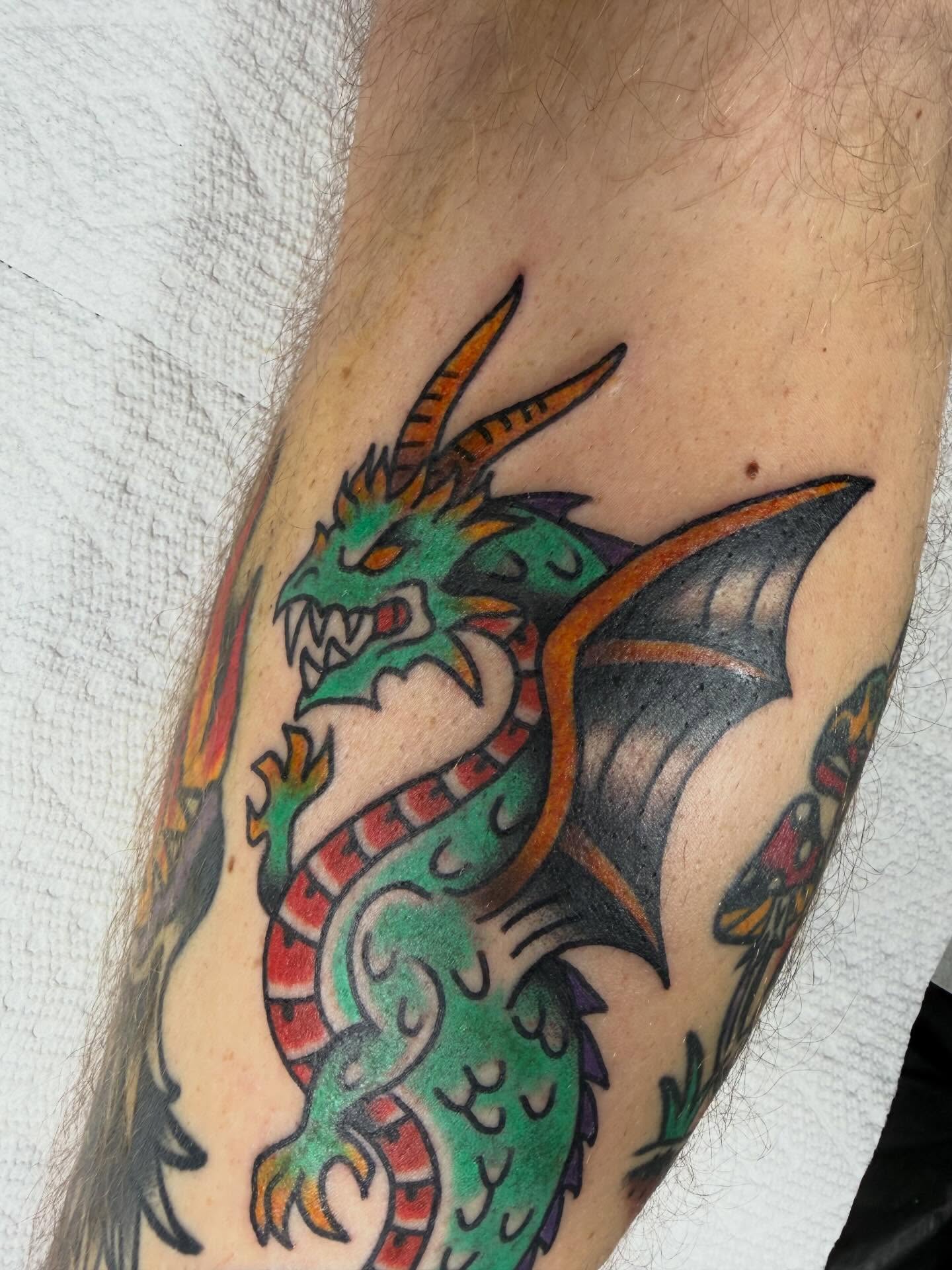 Dragon American traditional tattoo on the forearm by April Morris ⚔️ Tattoo Goblin