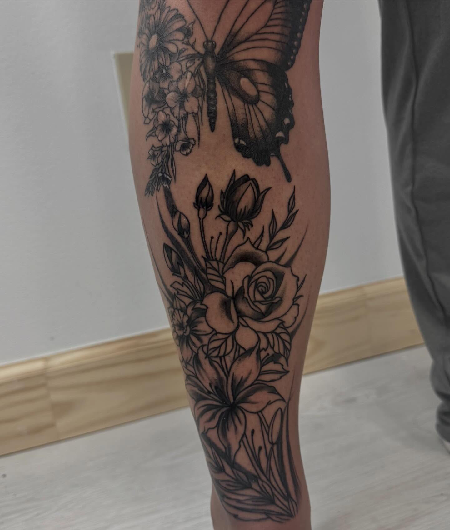 Butterfly and floral bouquet realism tattoo on the forearm by Gigi