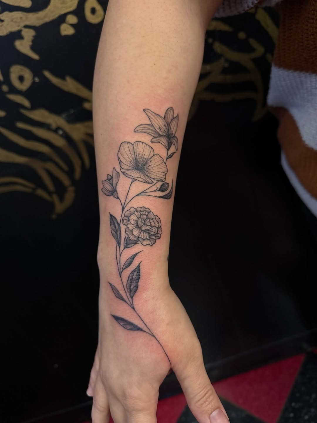 Floral branch fine line tattoo on the forearm by 𝕯𝖆𝖓𝖎