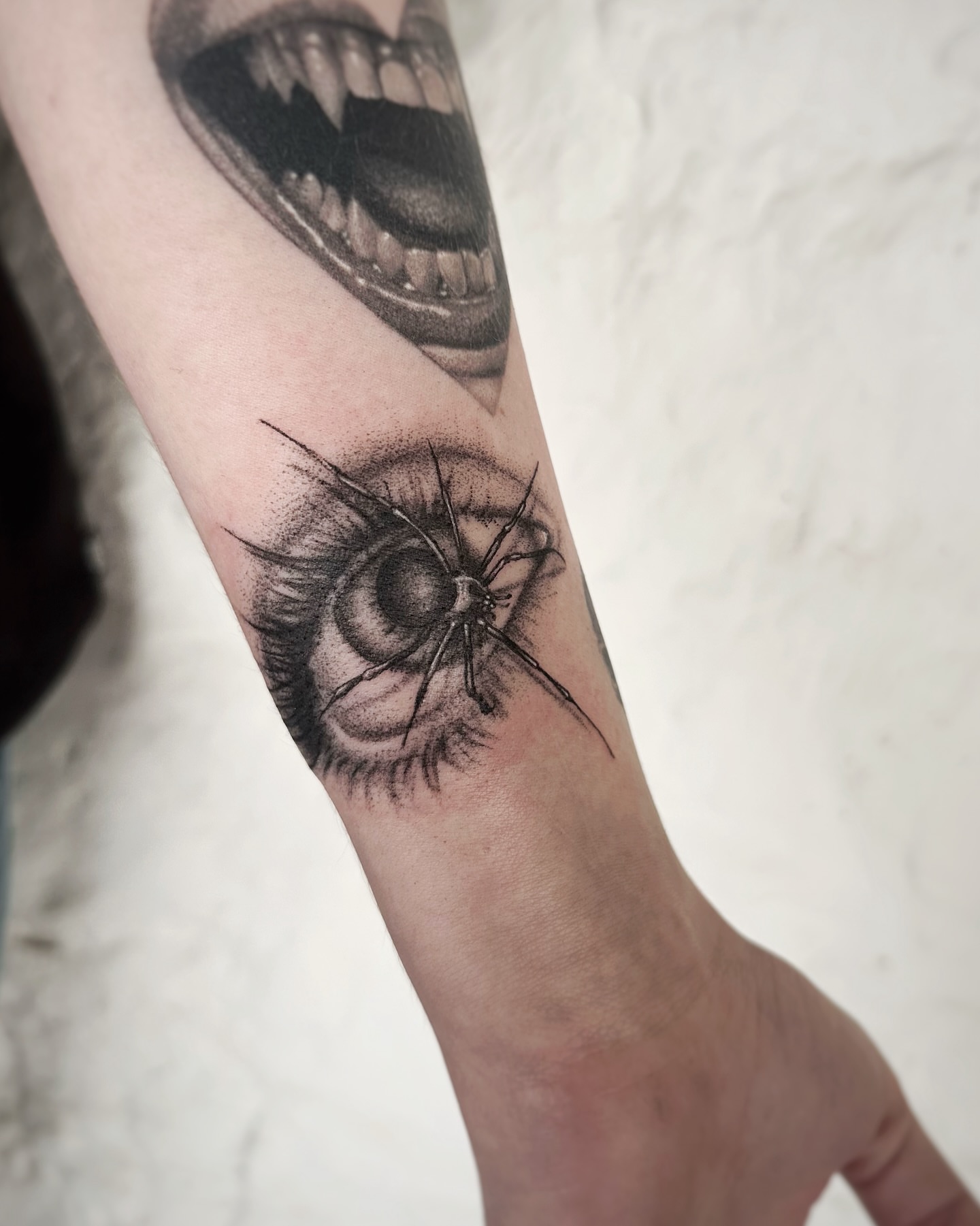 Eye with spider dotwork tattoo on the forearm by Micky, Austin, Texas