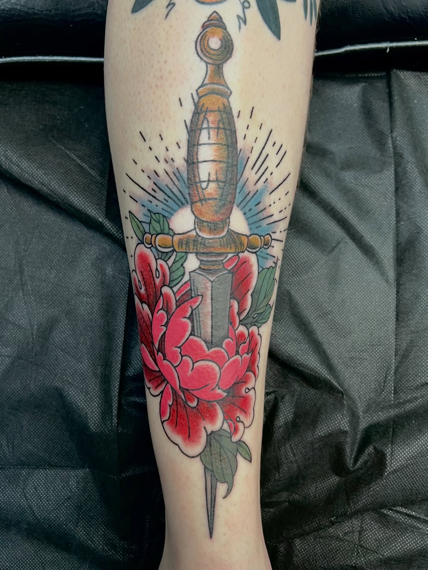 Knife and flowers American traditional tattoo on the forearm by Abbi