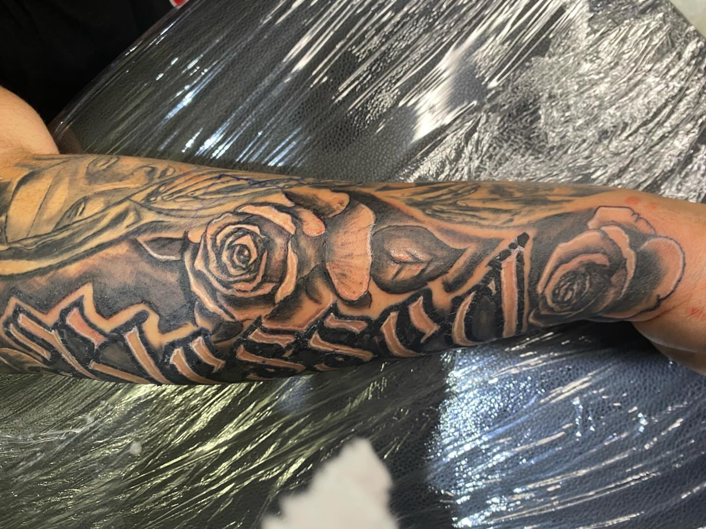 Roses black and grey tattoo on the forearm by Illuminink.gallery