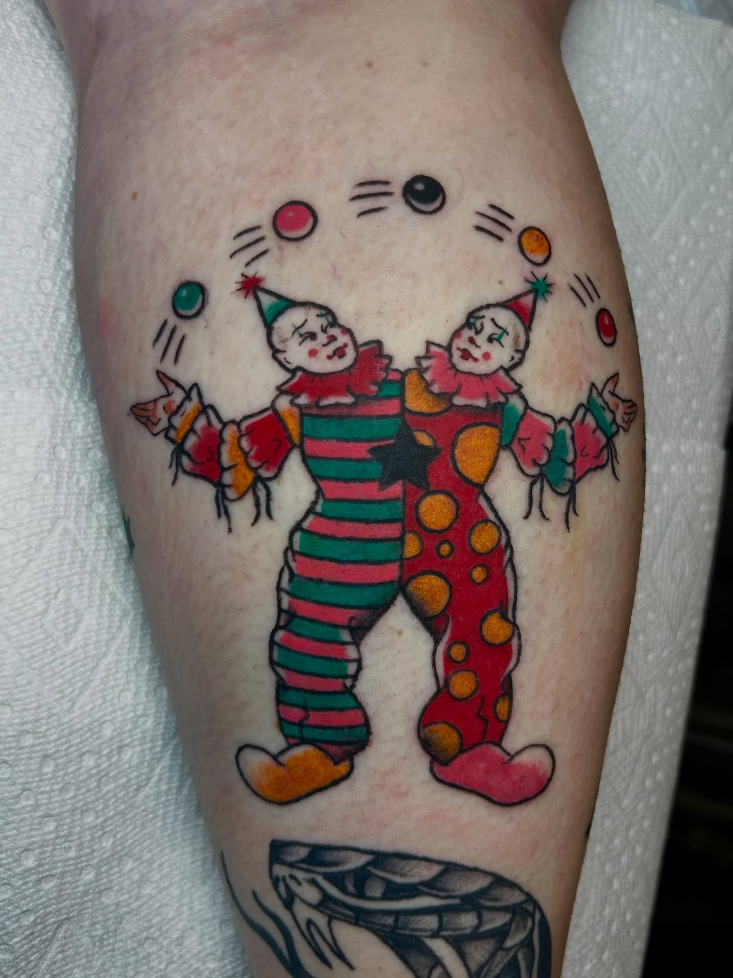 Clowns American traditional tattoo on the forearm by Lily May