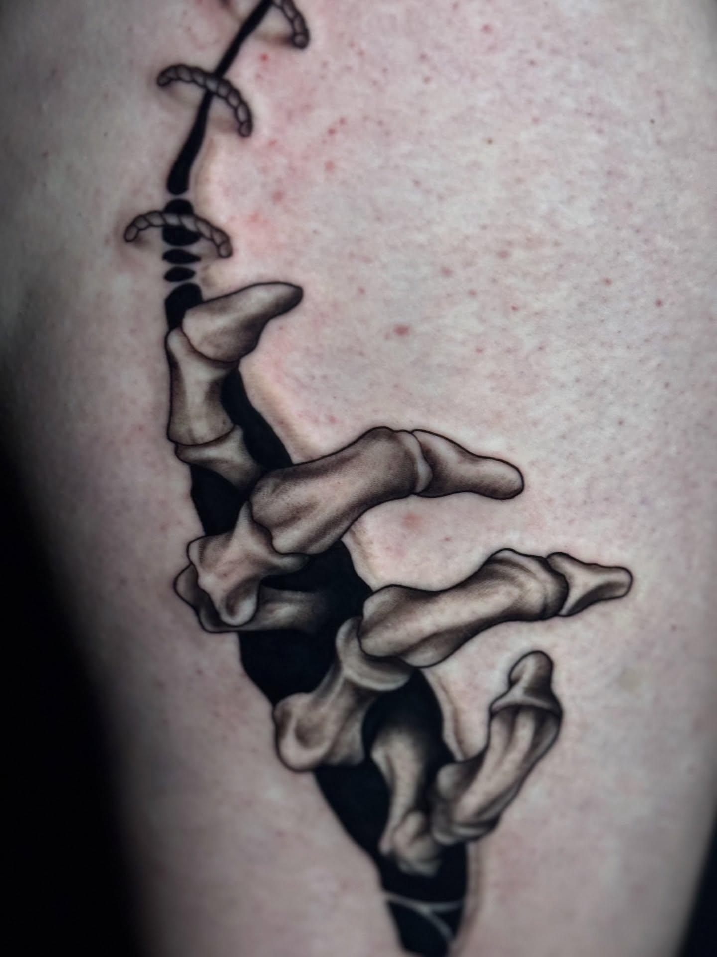 Spine black and grey tattoo on the thigh by Lily Bejarno