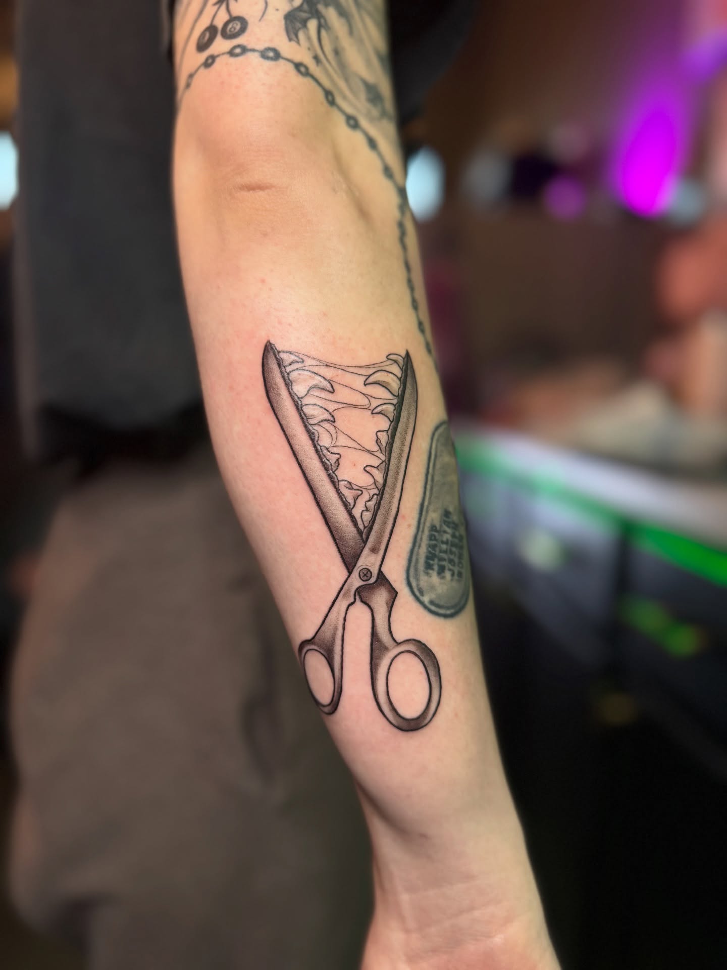 Scissors black and grey tattoo on the forearm by Lily Bejarno