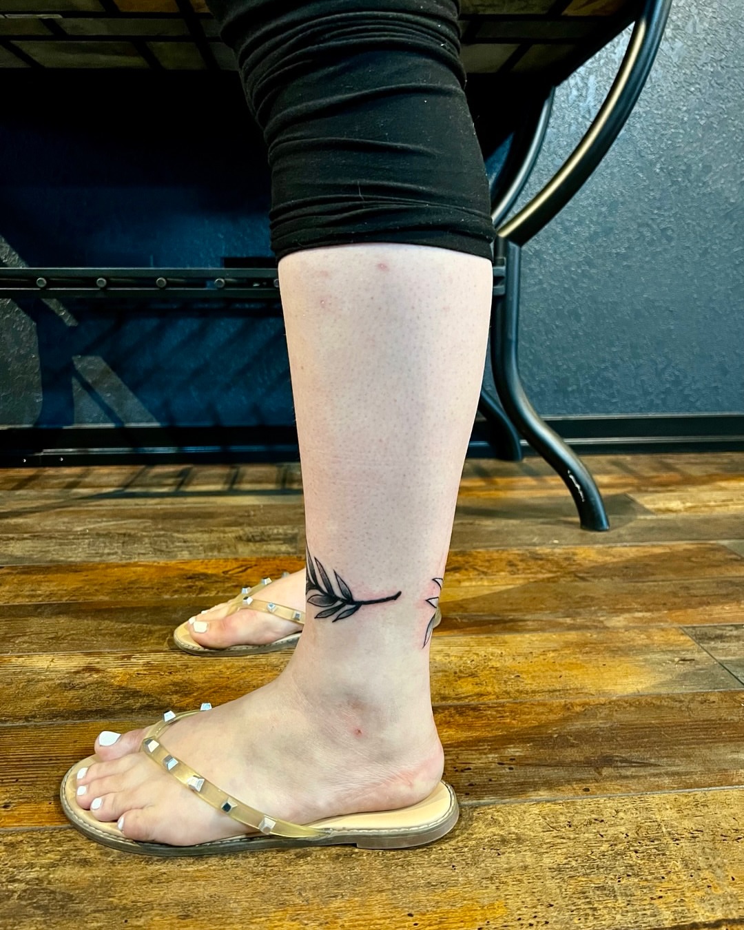 Feather black and grey tattoo on the foot by Deacon Moser