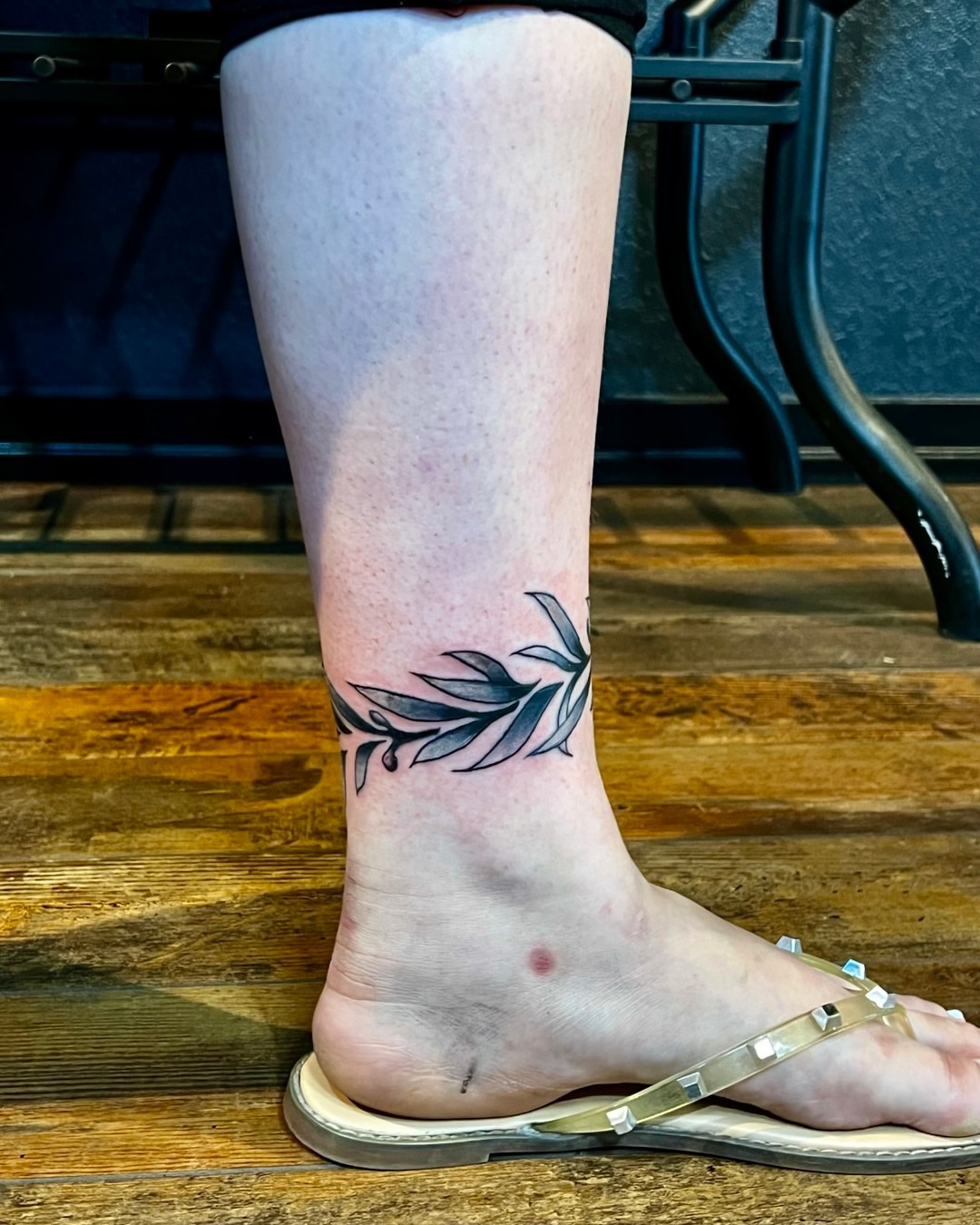 Leaf black and grey tattoo on the calf by Deacon Moser