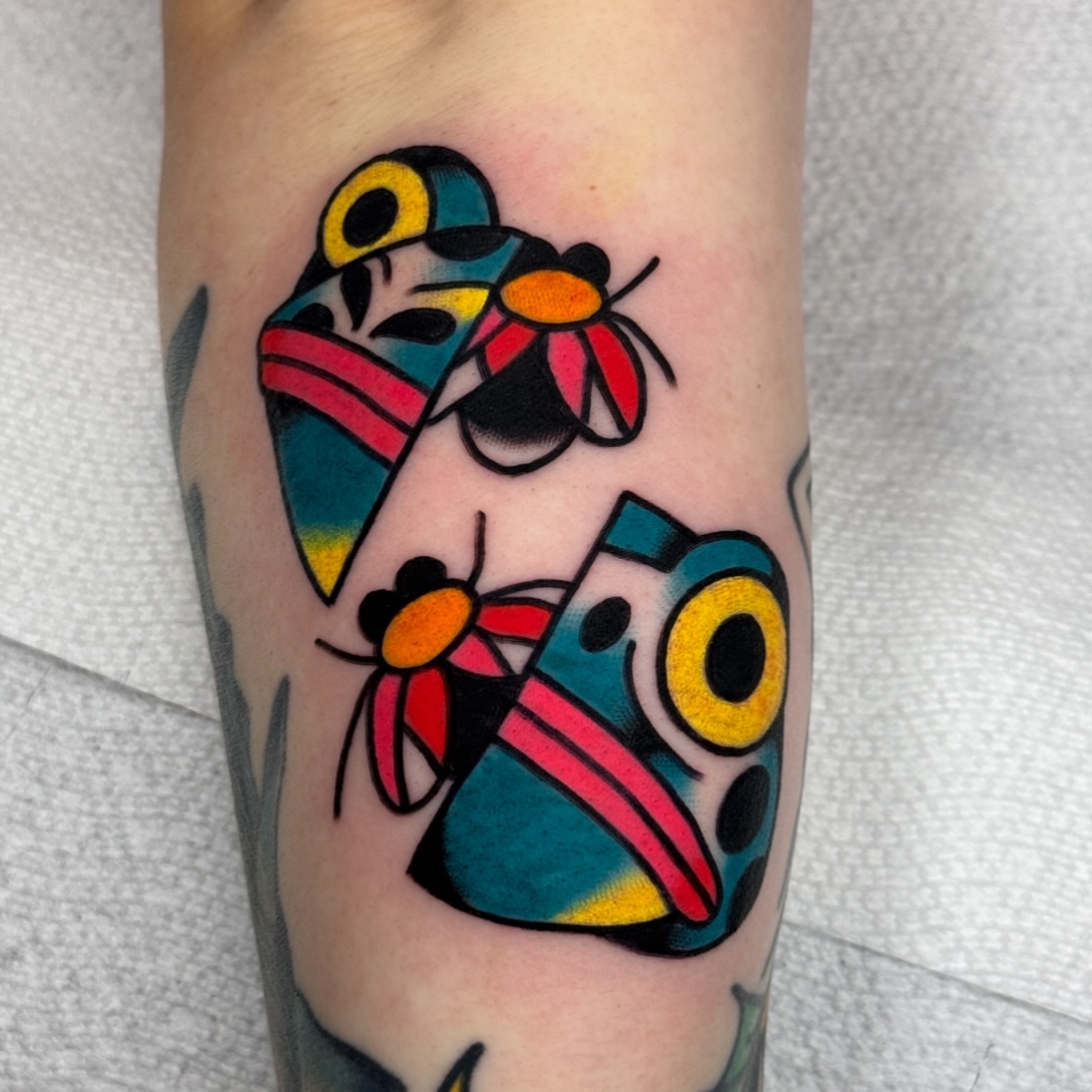 Abstract shapes American traditional tattoo on the forearm by Jess Baker