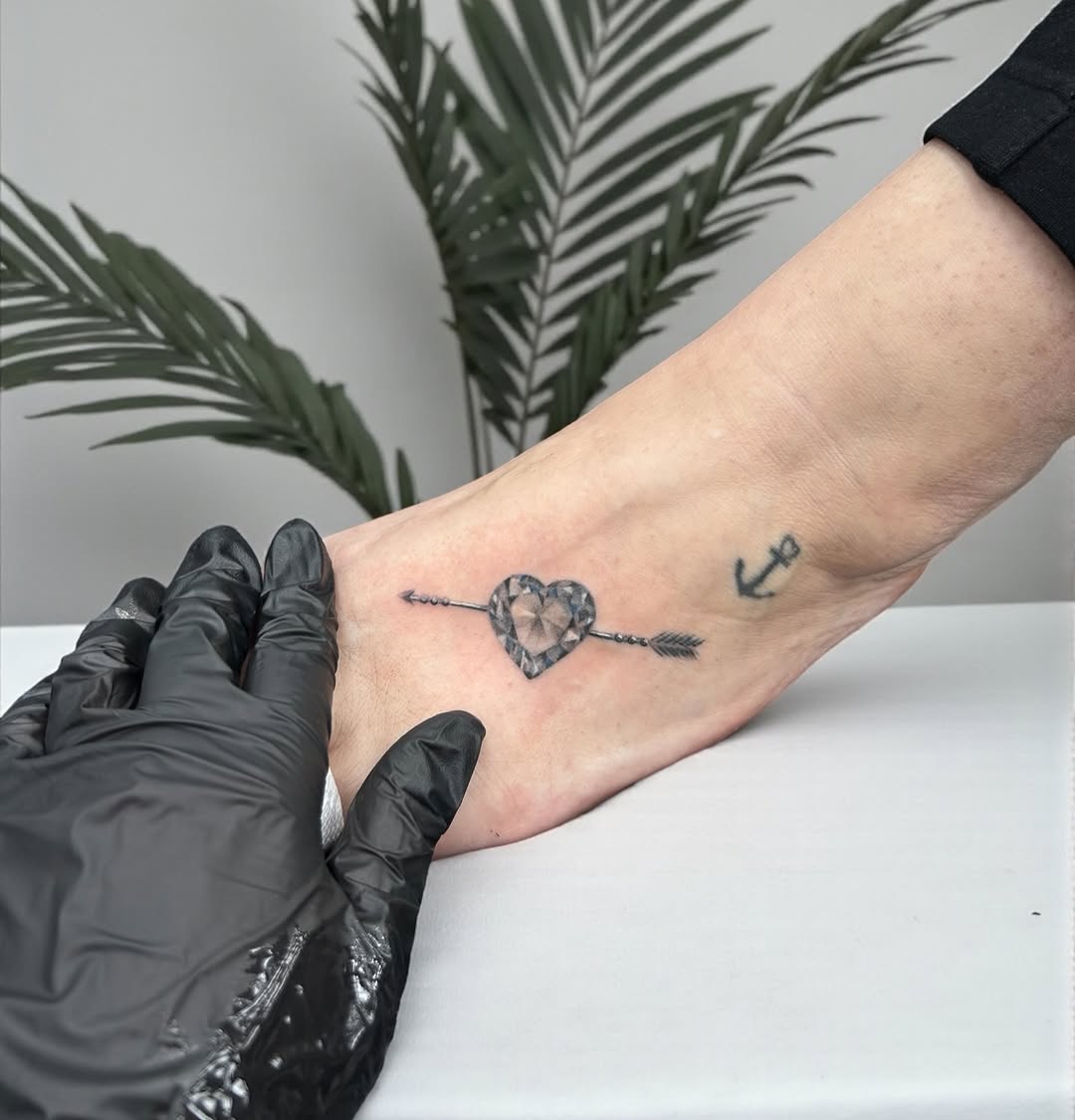 Diamond heart with arrow ornamental tattoo on the foot by Lina Valentina, New York, New York