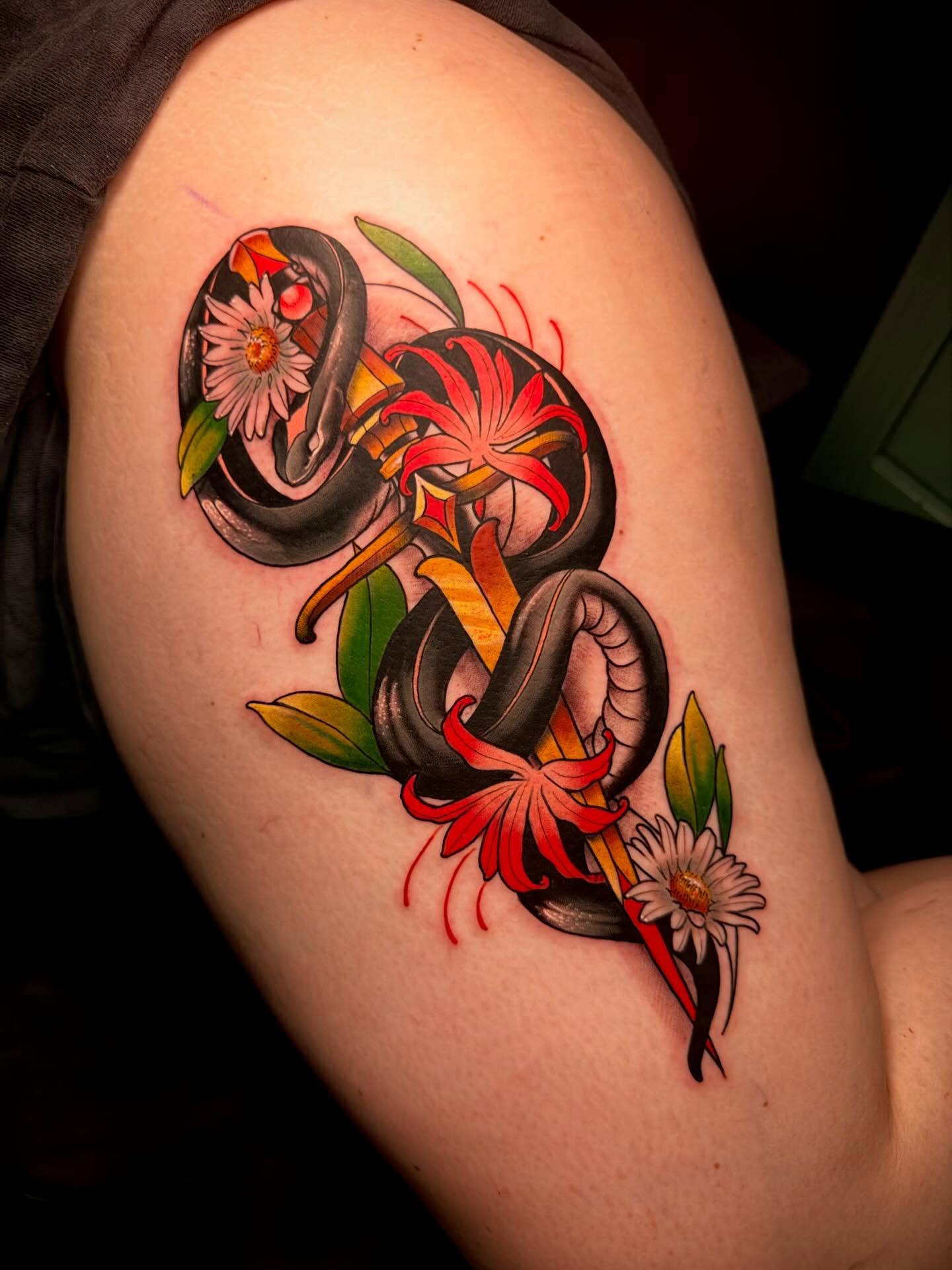 Snake and flowers American traditional tattoo on the shoulder by Robert Graye