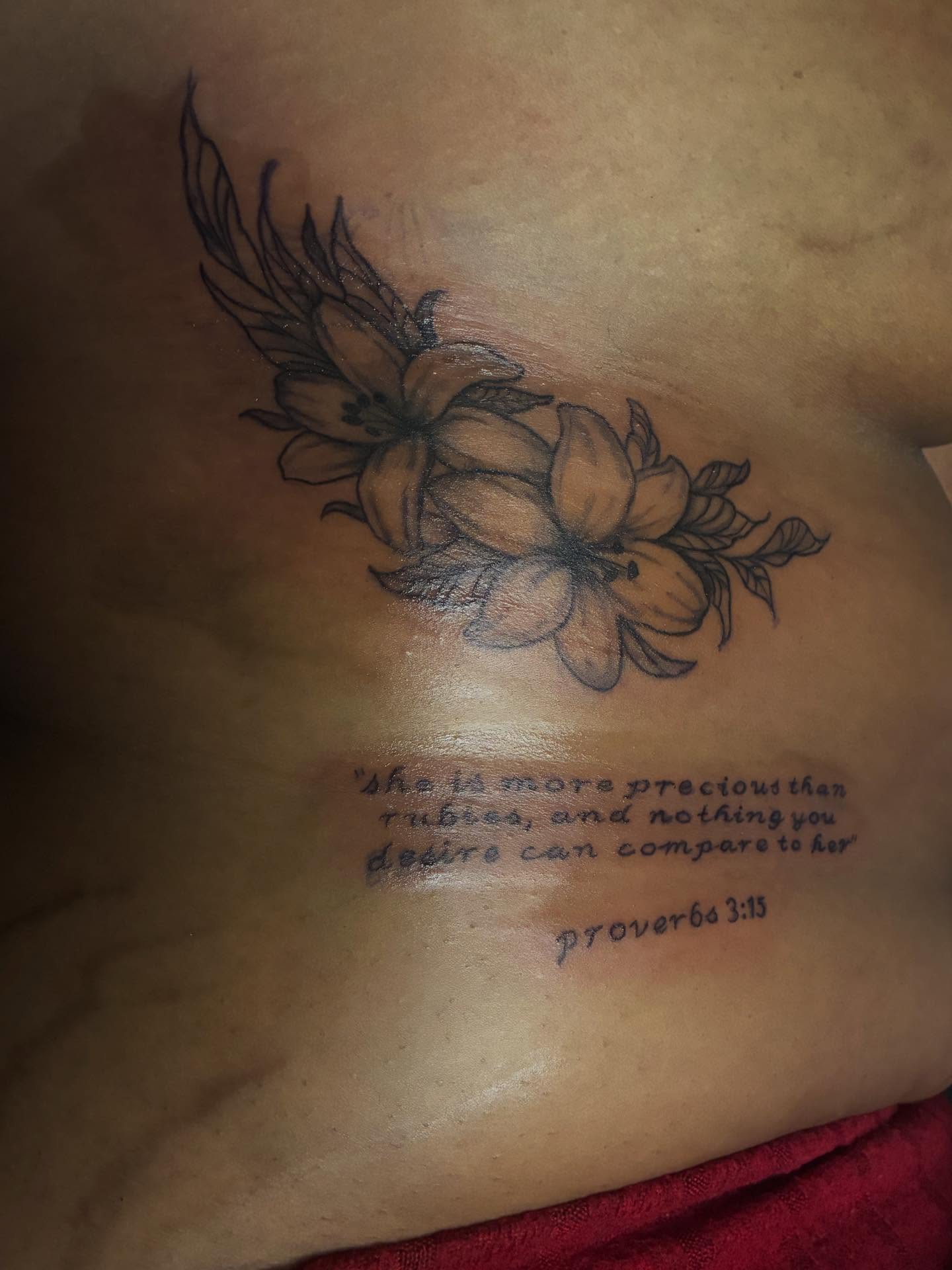 Flowers and verse black and grey tattoo on the ribs by Detroit tattoo Artist