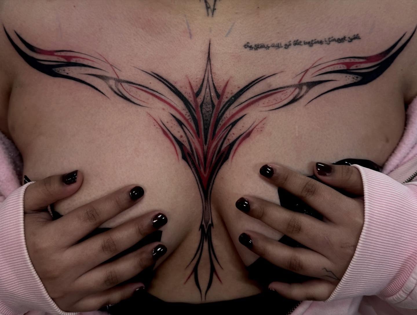 Floral tribal tattoo on the chest by Claire Litsey