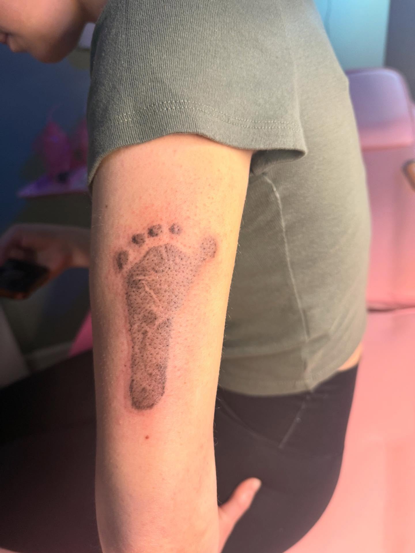 Footprint dotwork tattoo on the forearm by Tattoos by Santos