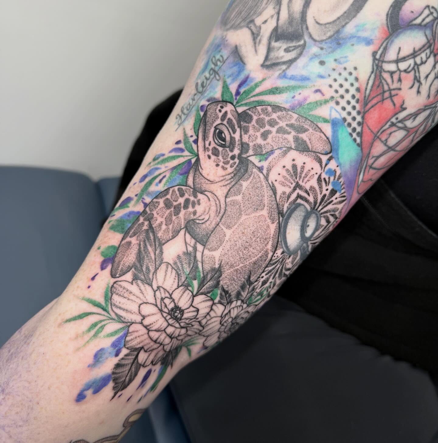 Sea turtle and flowers dotwork tattoo on the forearm by Abby