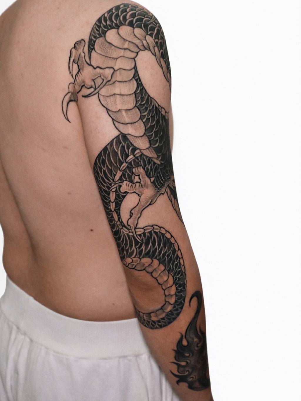 Snake black and grey tattoo on the upper arm by elvis flores