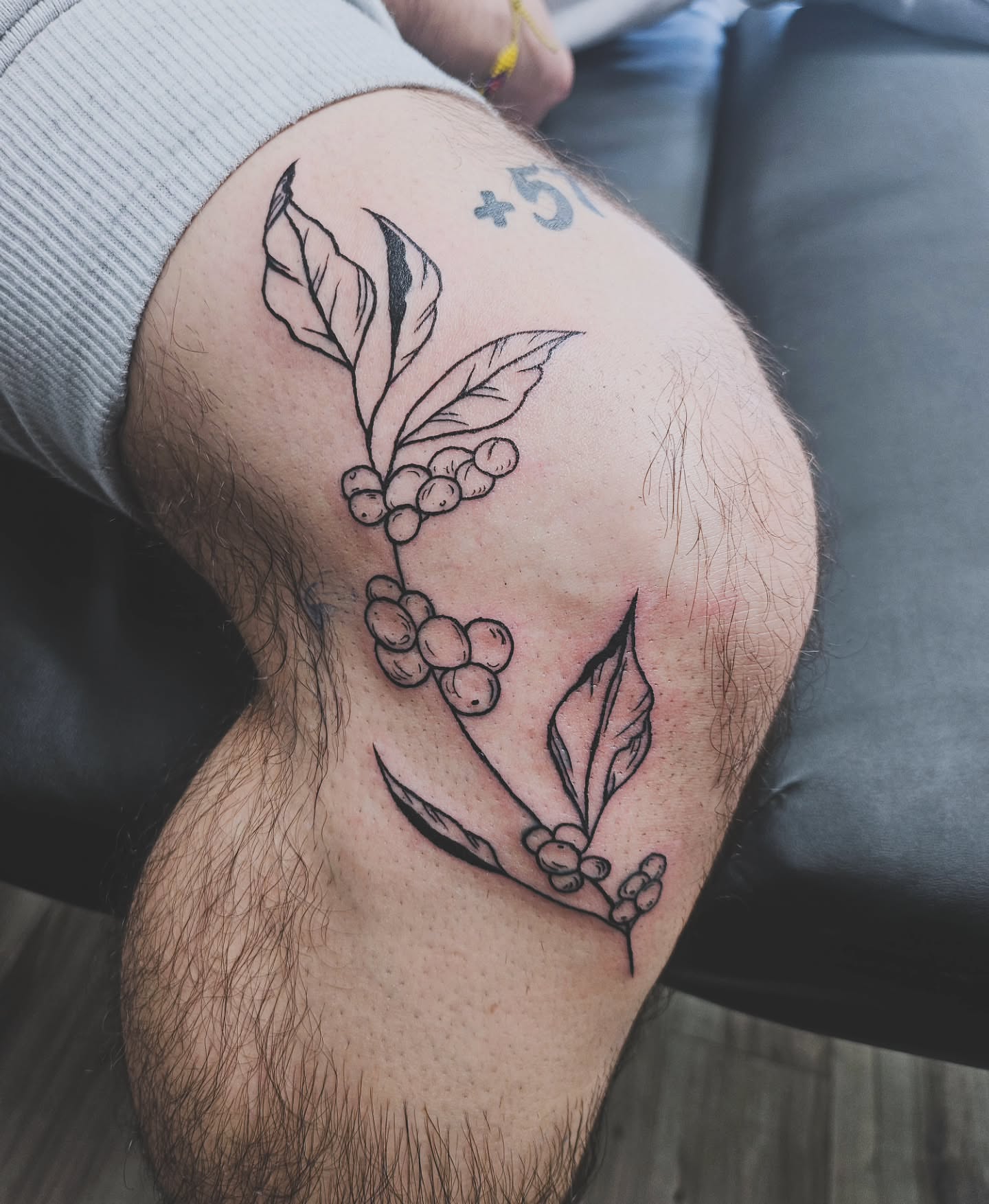 Coffee beans and leaves black and grey tattoo on the thigh by ݁˖