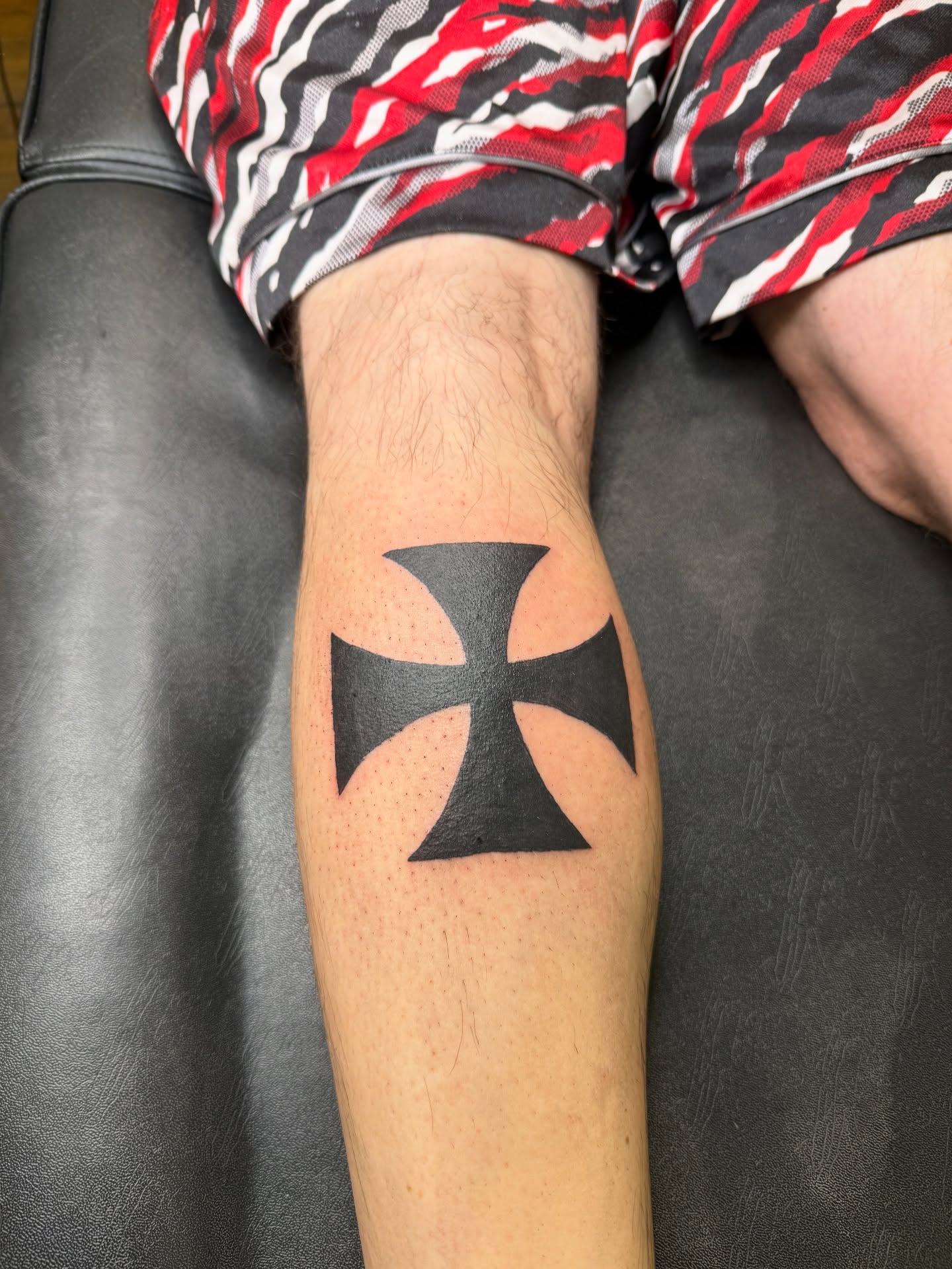 Iron cross black and grey tattoo on the forearm by Whimsy Ink
