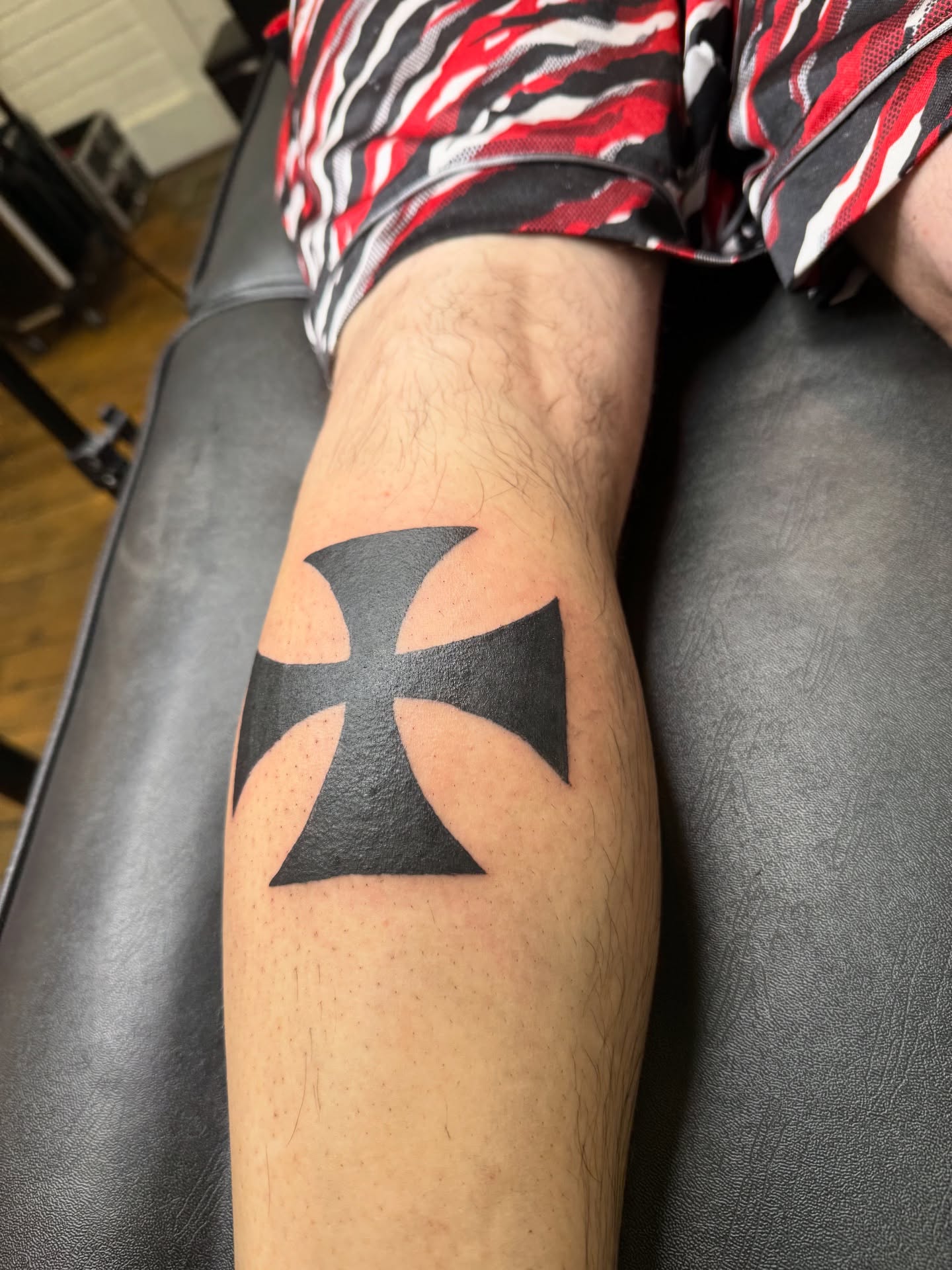Iron cross black and grey tattoo on the forearm by Whimsy Ink