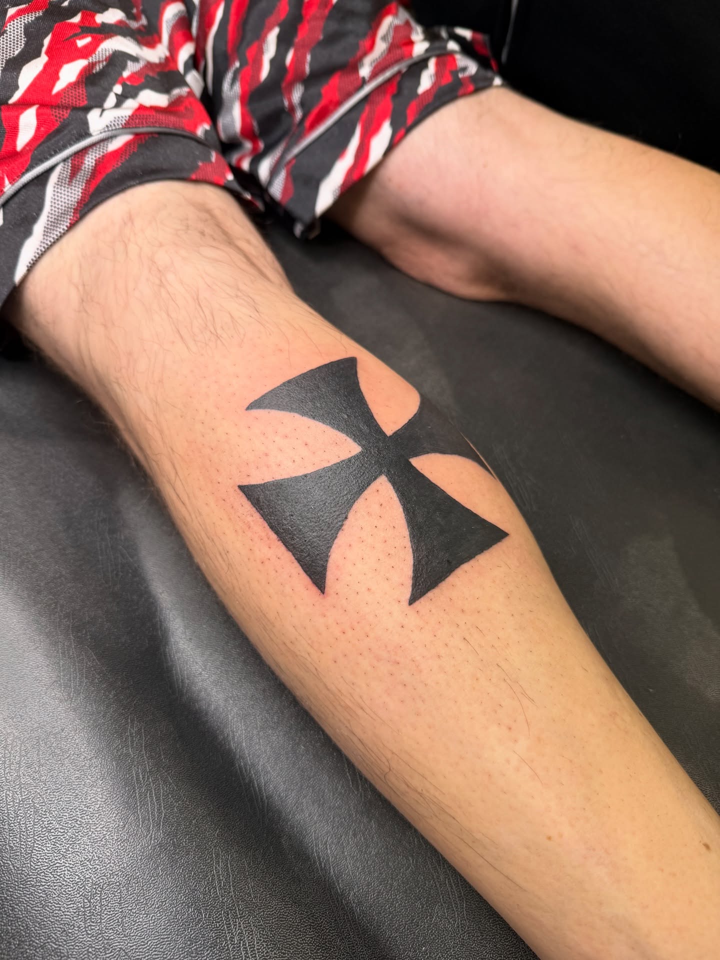 Iron cross black and grey tattoo on the forearm by Whimsy Ink