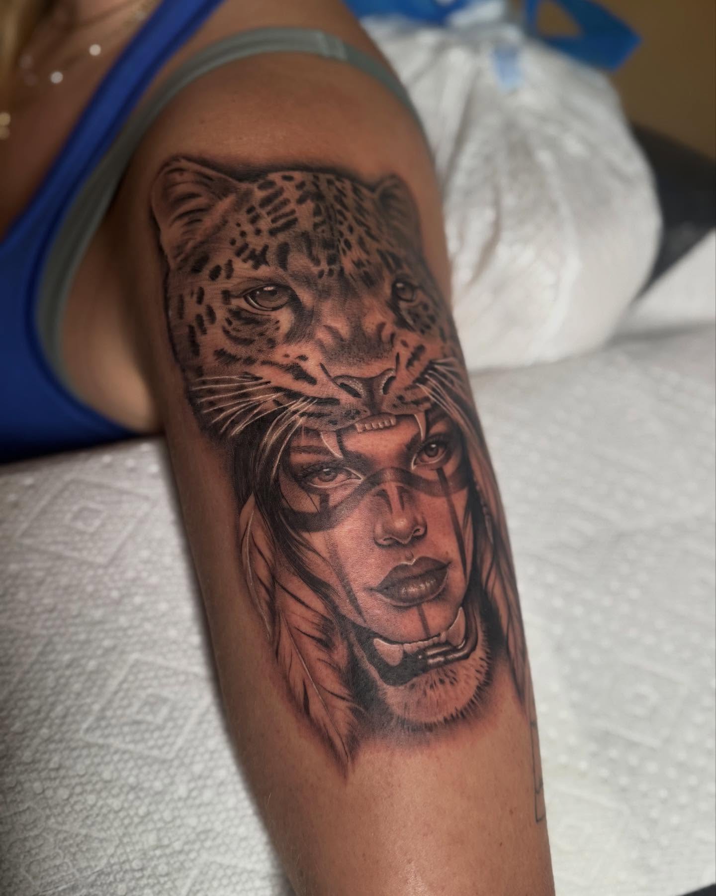 Woman with leopard realism tattoo on the forearm by Jas Knight