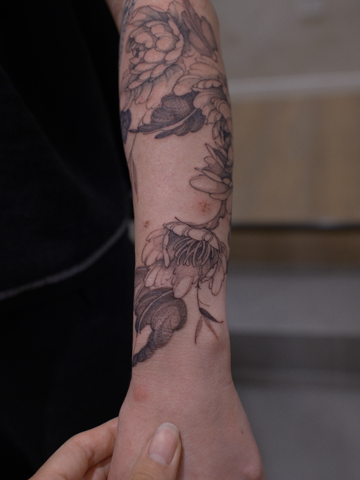 Floral arrangement black and grey tattoo on the forearm by Joy, Gold Coast, Queensland