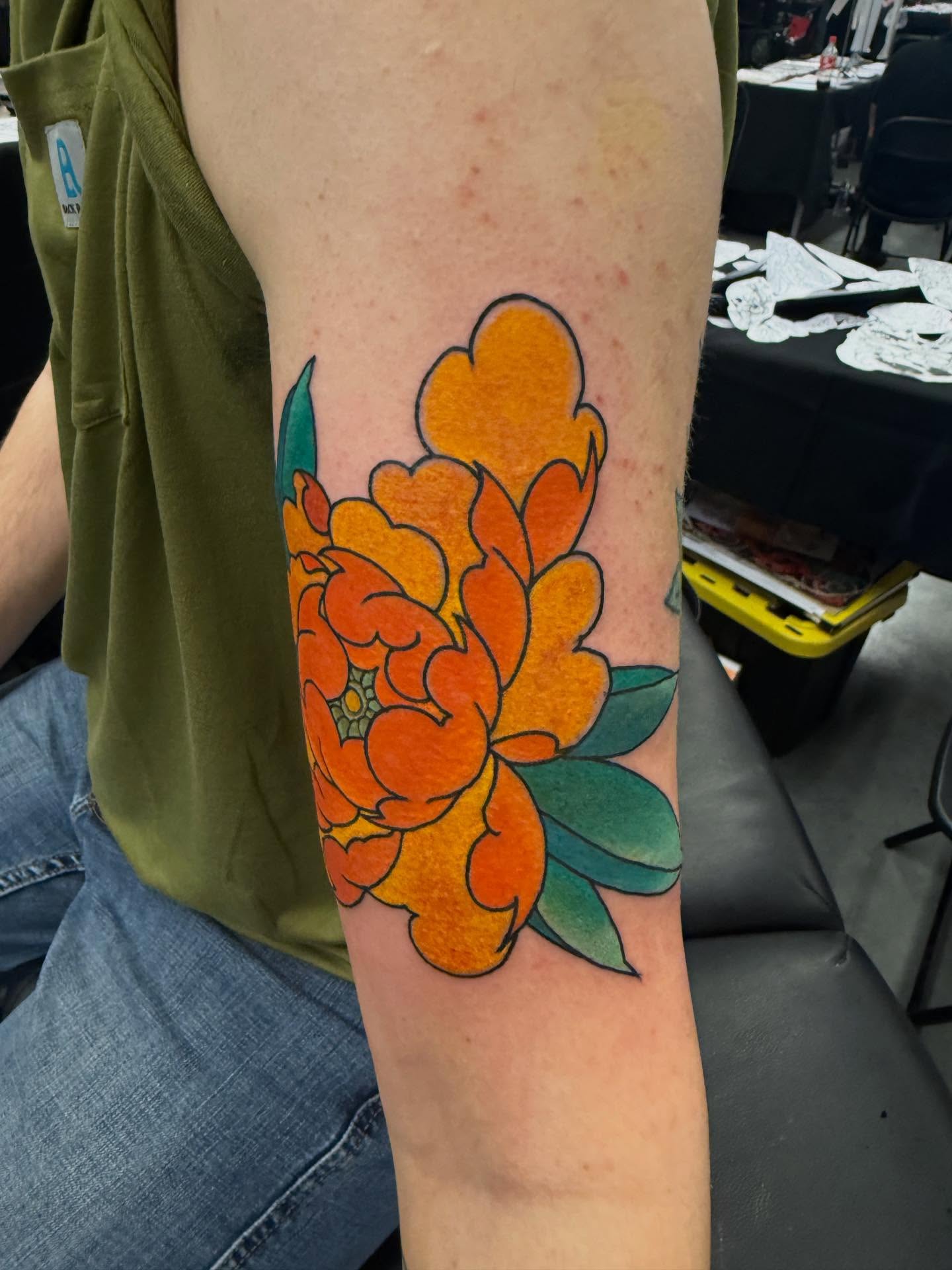 Peony watercolor tattoo on the forearm by Randall Croley El