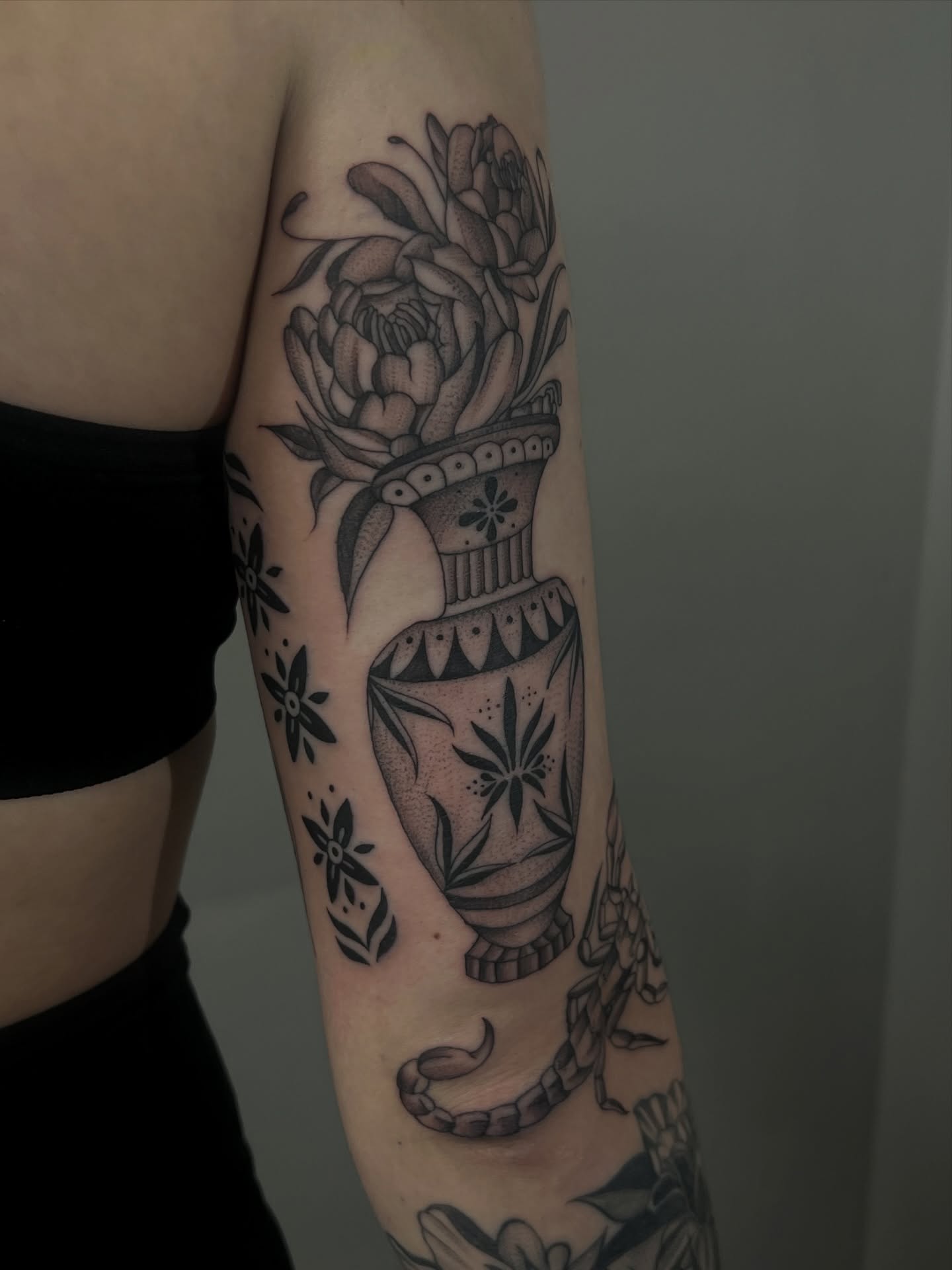 Vase with flowers American traditional tattoo on the forearm by ashlyn rene