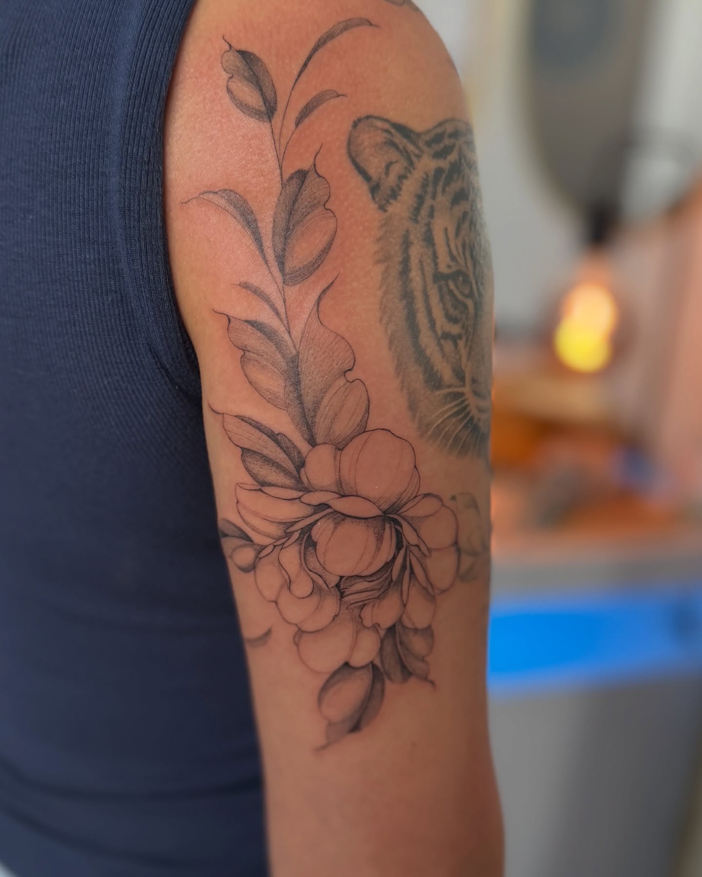 Tiger and floral bouquet realism tattoo on the forearm by Daniel Montoya, Charlotte, North Carolina